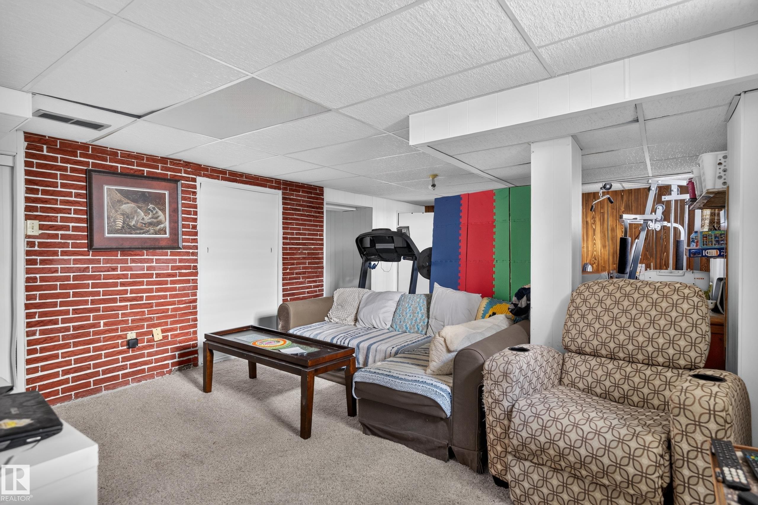 Red brick accent wall with two white doors - 12309 80 Street Nw, Edmonton, AB