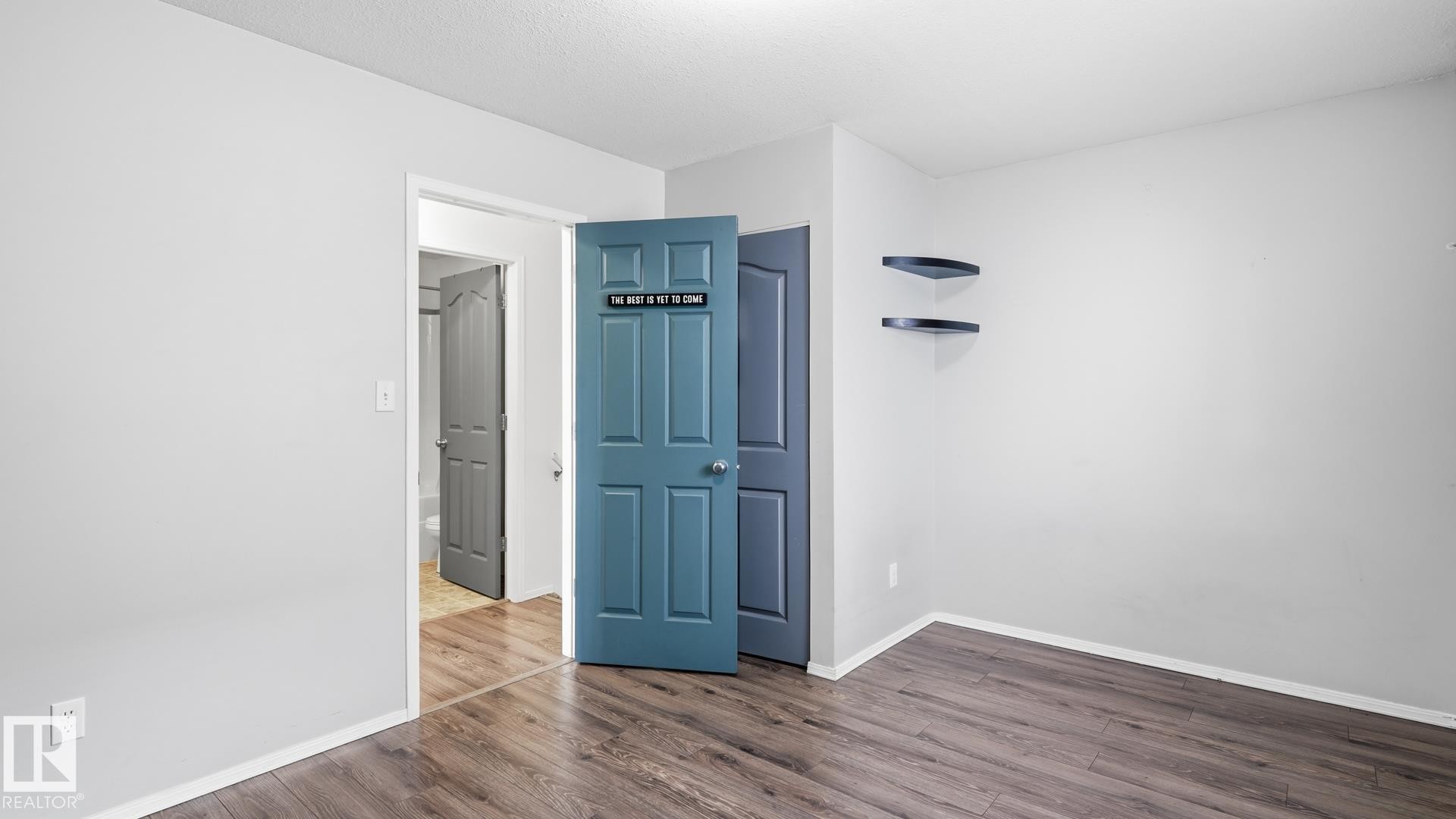 Wood-finish flooring throughout, light neutral wall paint, and white trim - 2117 36 Avenue Nw, Edmonton, AB