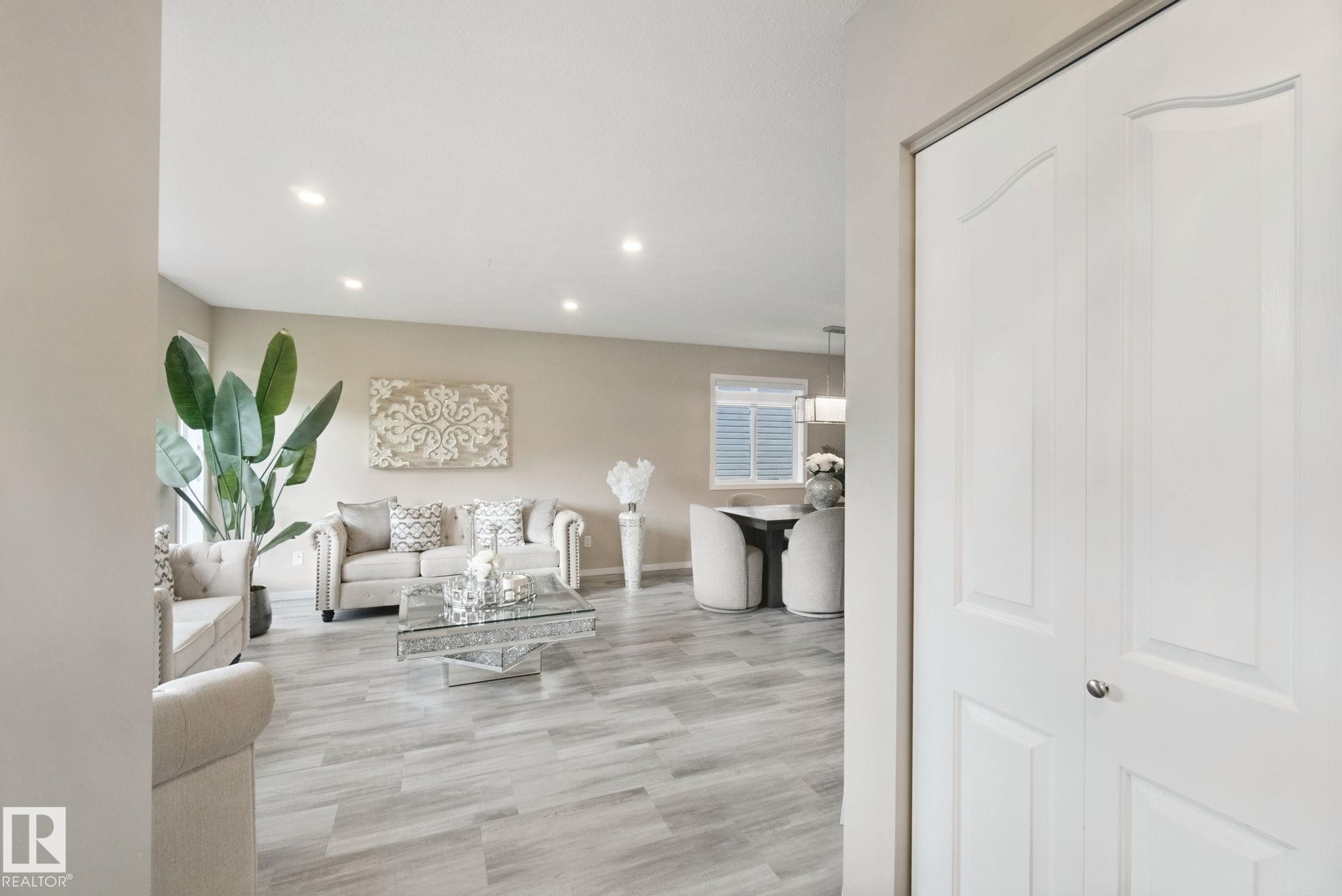 Recessed lighting illuminates the living space with light-tone walls and wood-finish flooring - 13912 156 Avenue Nw, Edmonton, AB