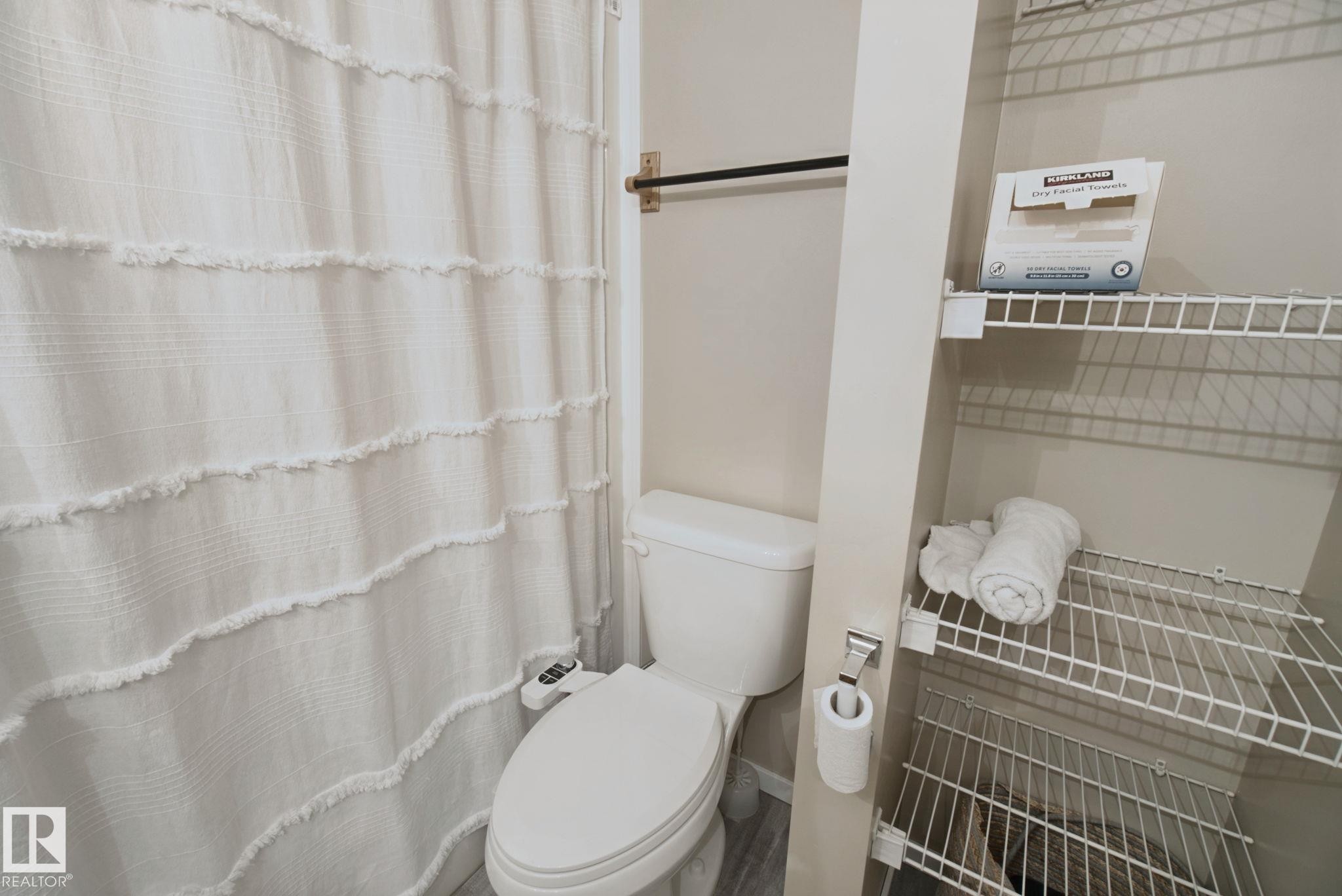 White toilet with an attached bidet - 13912 156 Avenue Nw, Edmonton, AB