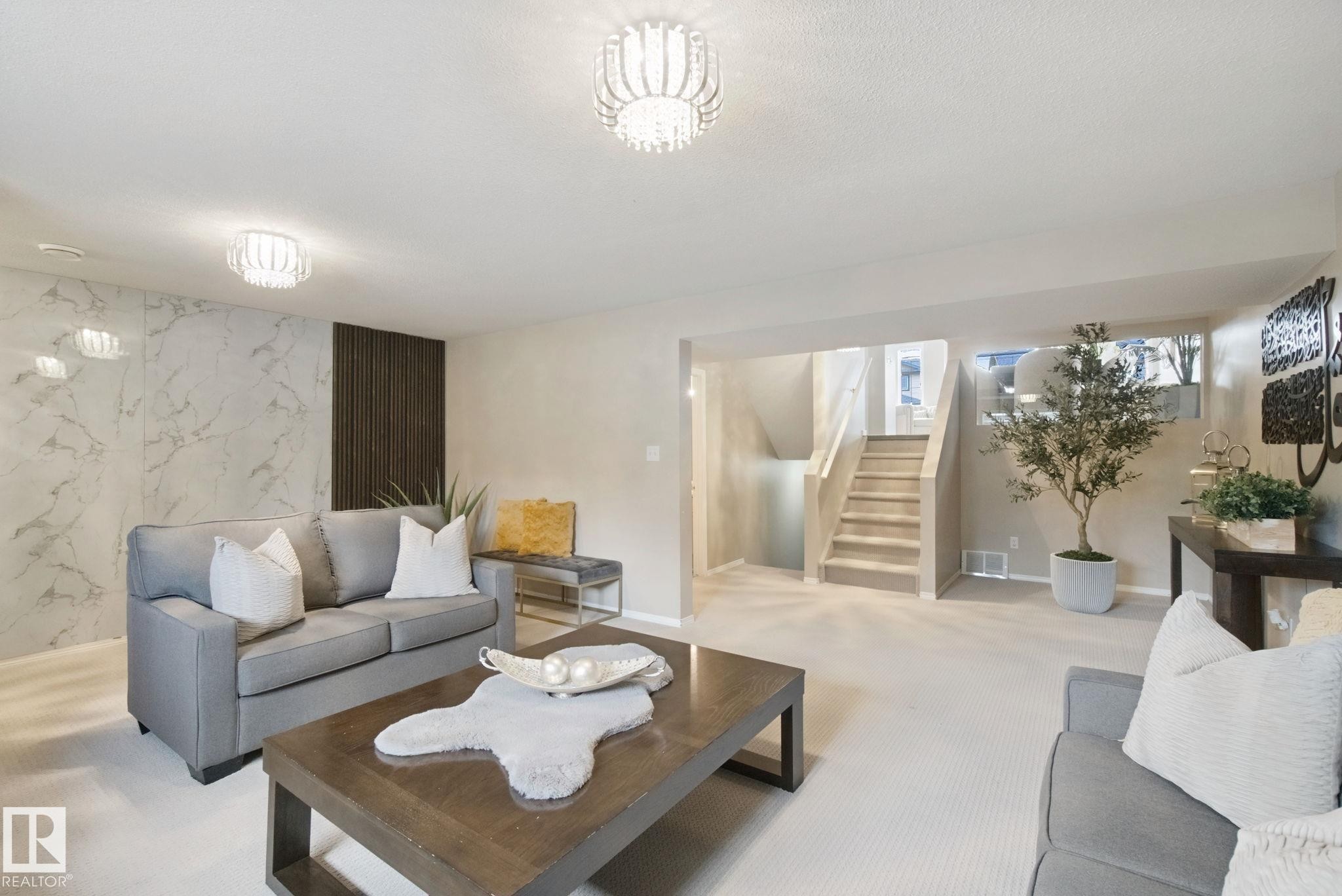 Plush carpeting throughout, decorative wall paneling, and elegant ceiling-mounted light fixtures - 13912 156 Avenue Nw, Edmonton, AB