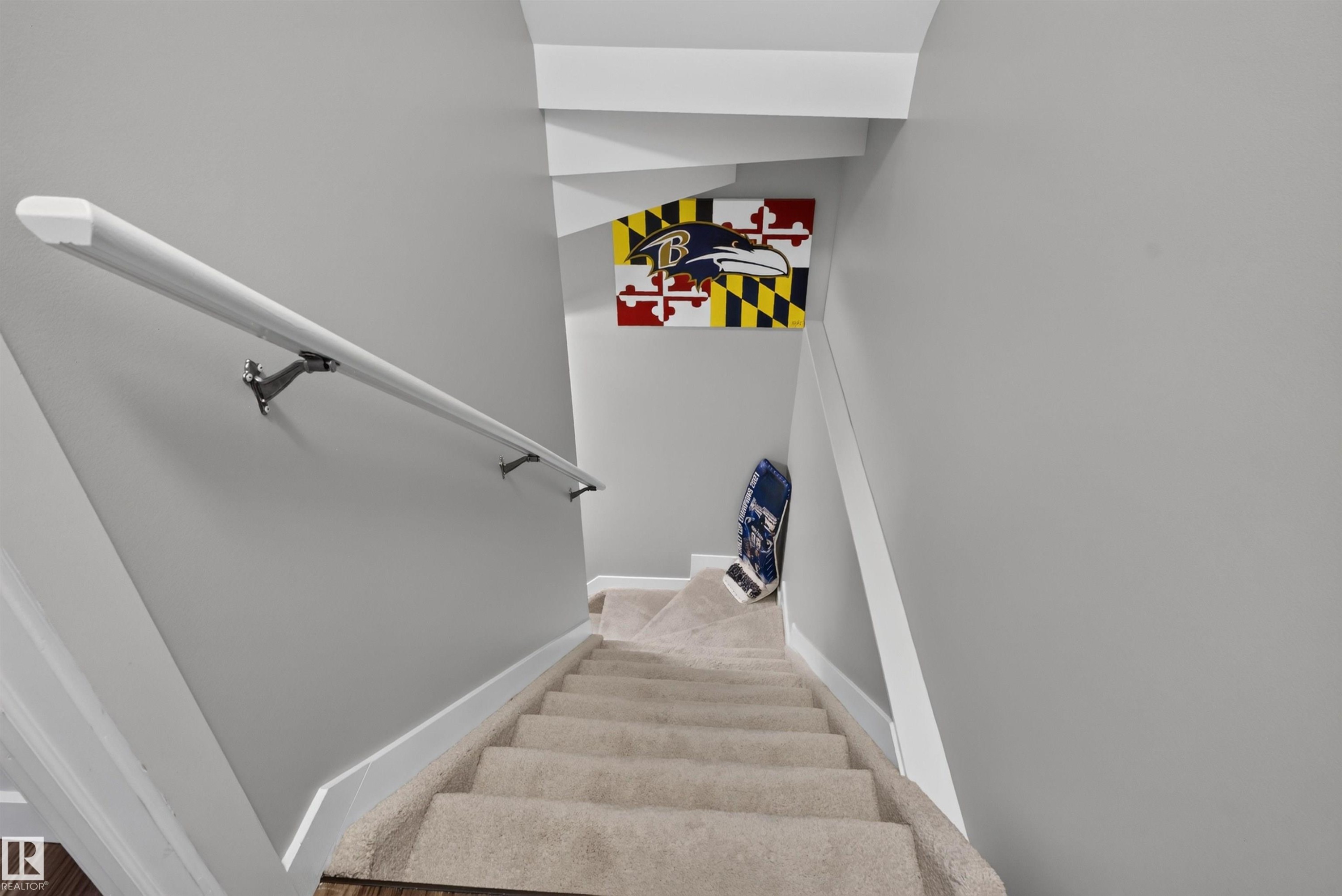 Carpeted staircase with light gray wall paint and white trim - 319 Desrochers Boulevard Sw, Edmonton, AB