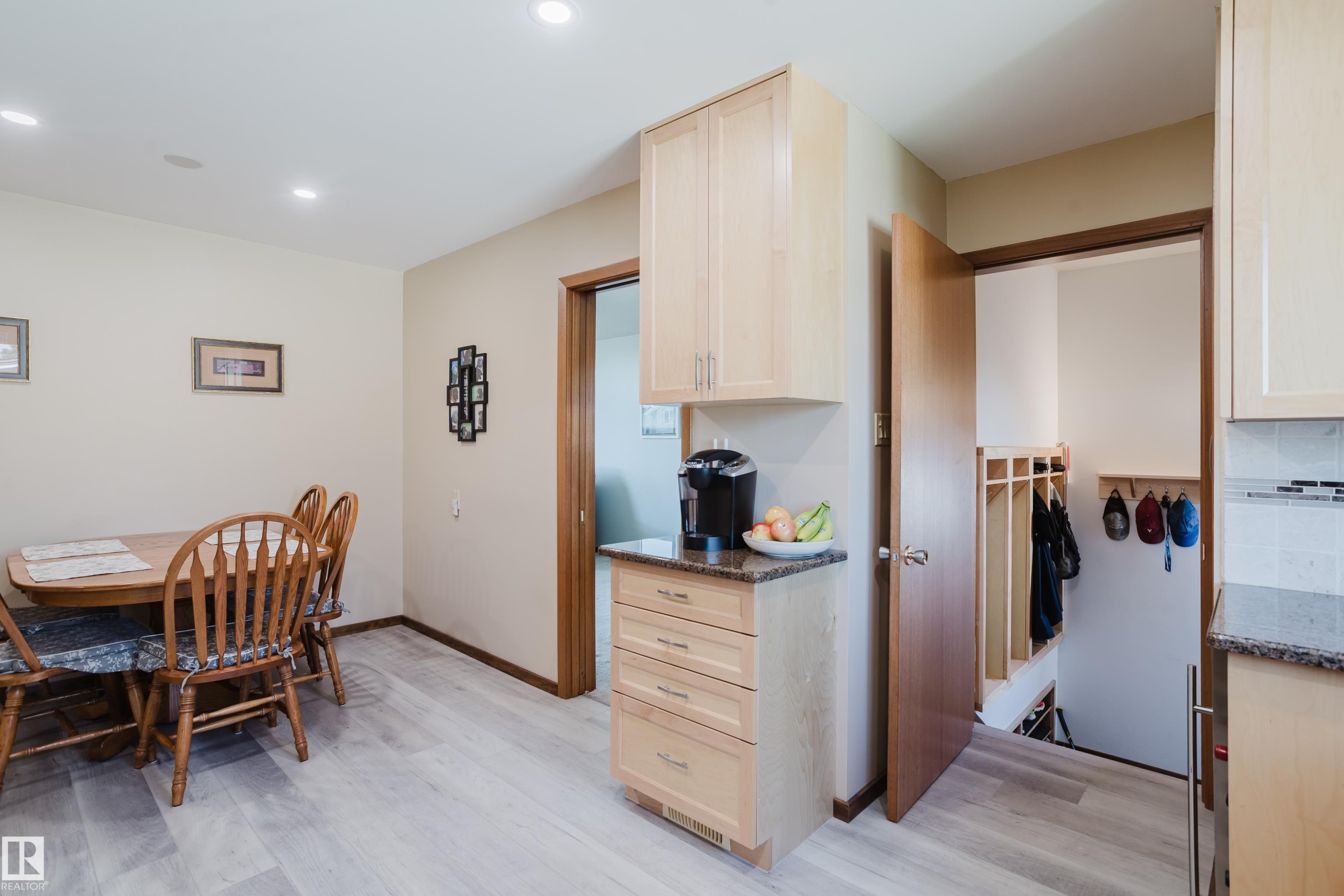 Recessed lighting illuminates the dining area, featuring wood-finish flooring - 10924 35A Avenue Nw, Edmonton, AB