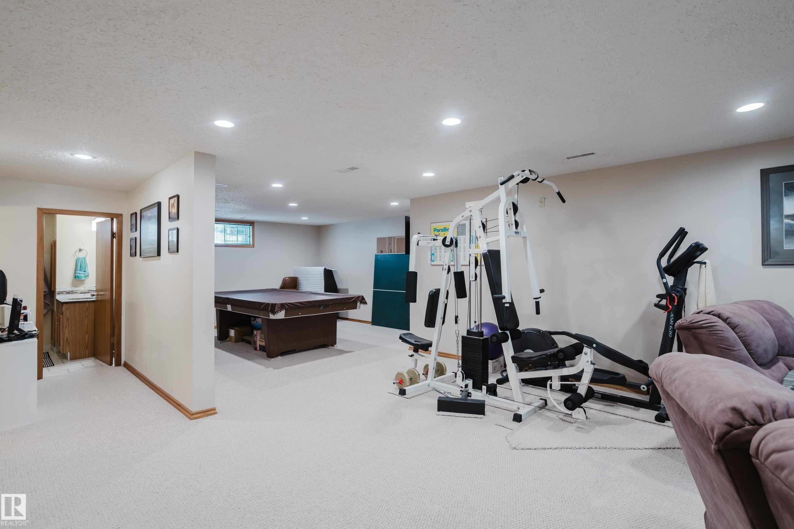 Recessed lighting, wood-finish trim, light-toned carpeting, and a built-in vanity with wood-finish cabinetry - 10924 35A Avenue Nw, Edmonton, AB