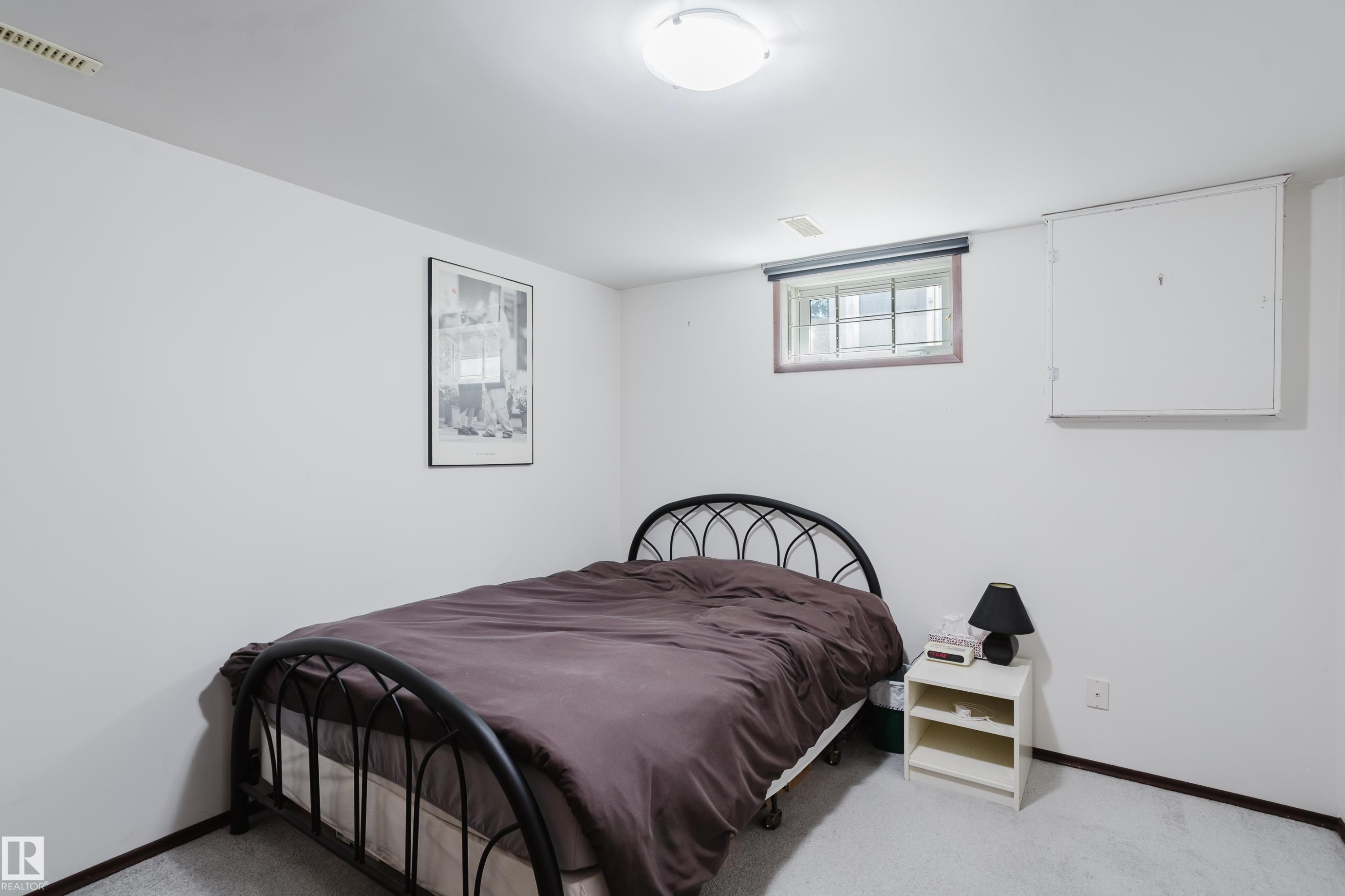 Recessed window with wood-finish trim, white painted walls, and light-colored carpeting - 10924 35A Avenue Nw, Edmonton, AB