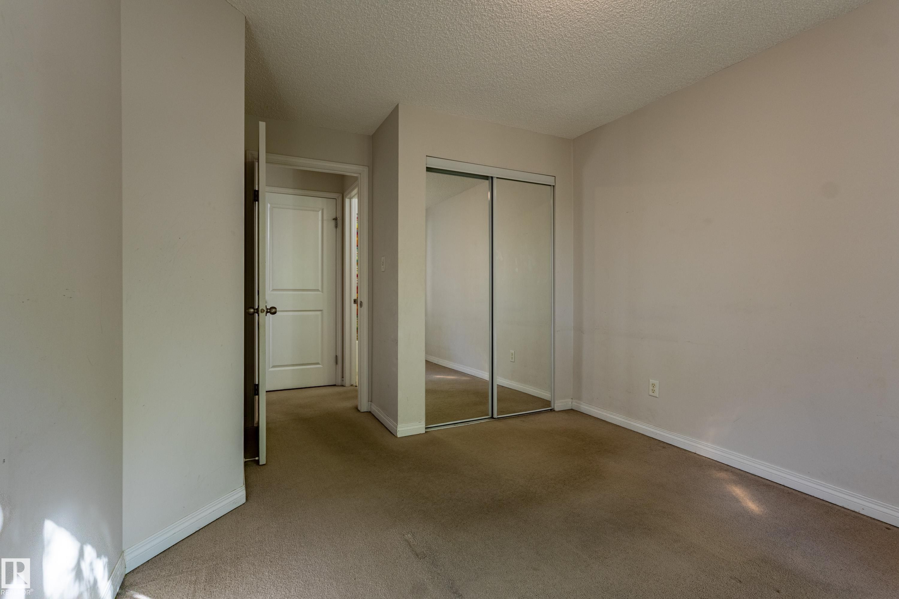 Neutral-toned walls complement the carpeted flooring - #316 11325 83 St Nw, Edmonton, AB
