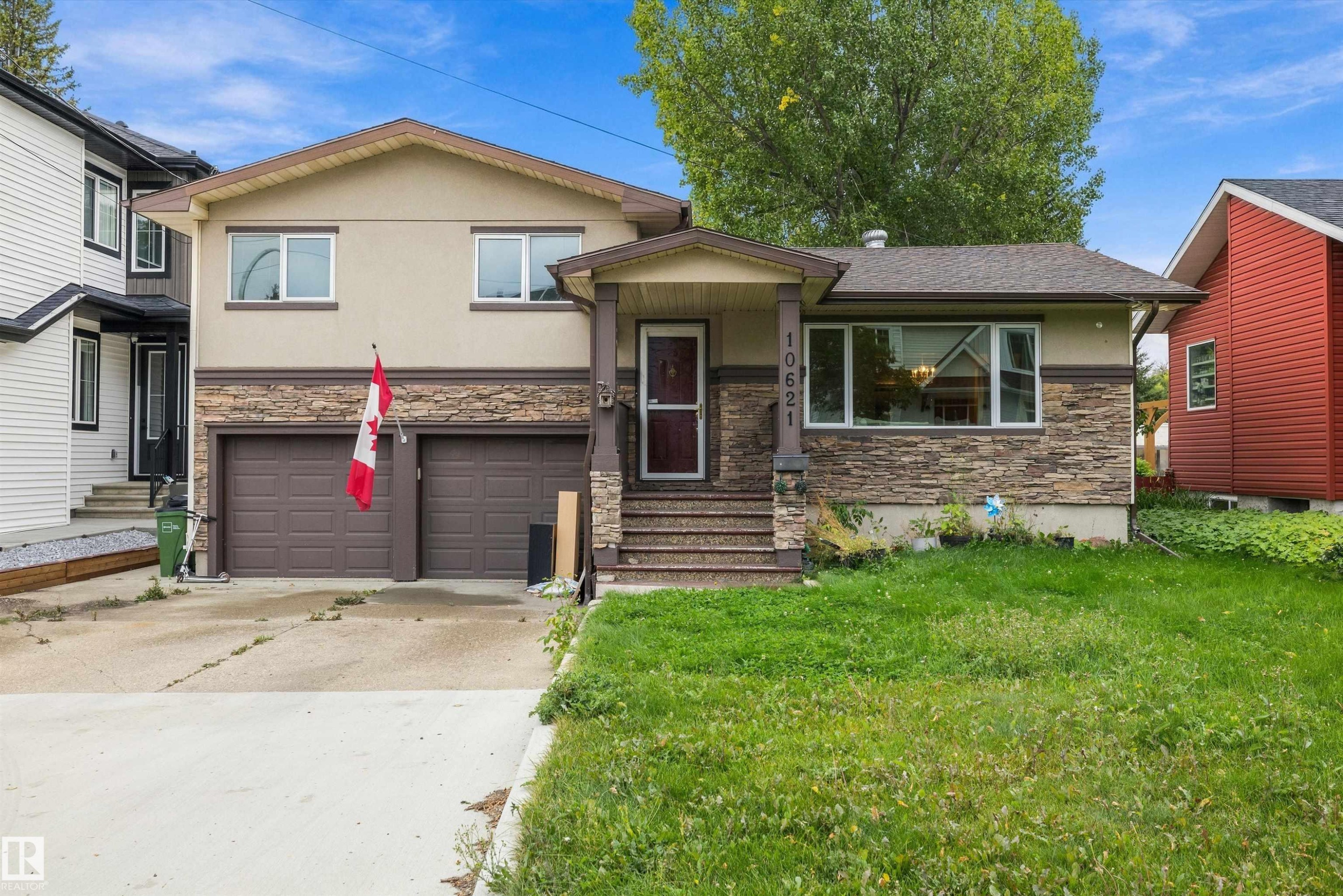 Two-story residence featuring a two-car garage, stone and stucco exterior, and a covered front entry - 10621 60A Avenue Nw, Edmonton, AB