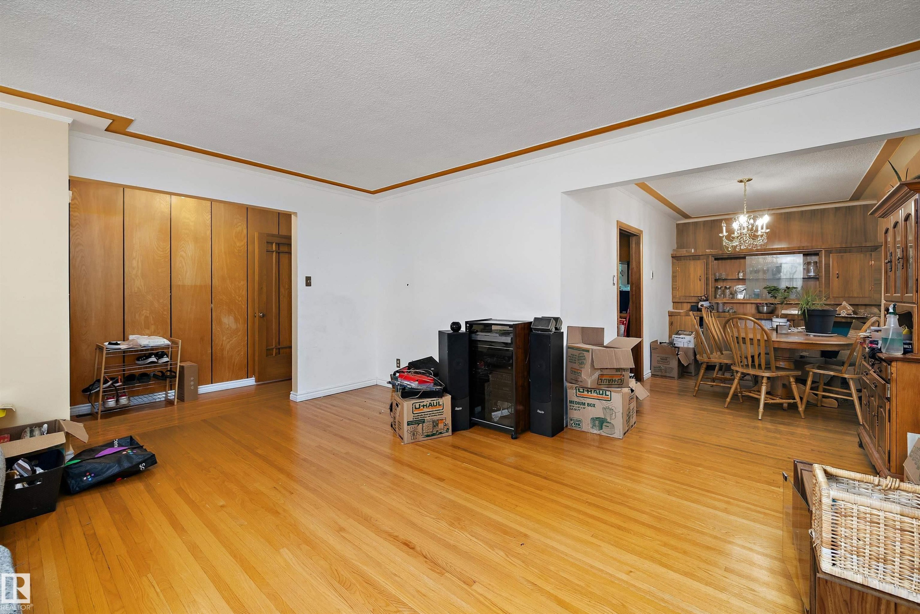Hardwood flooring, wood paneling, decorative ceiling trim, recessed dining area, chandelier - 10621 60A Avenue Nw, Edmonton, AB