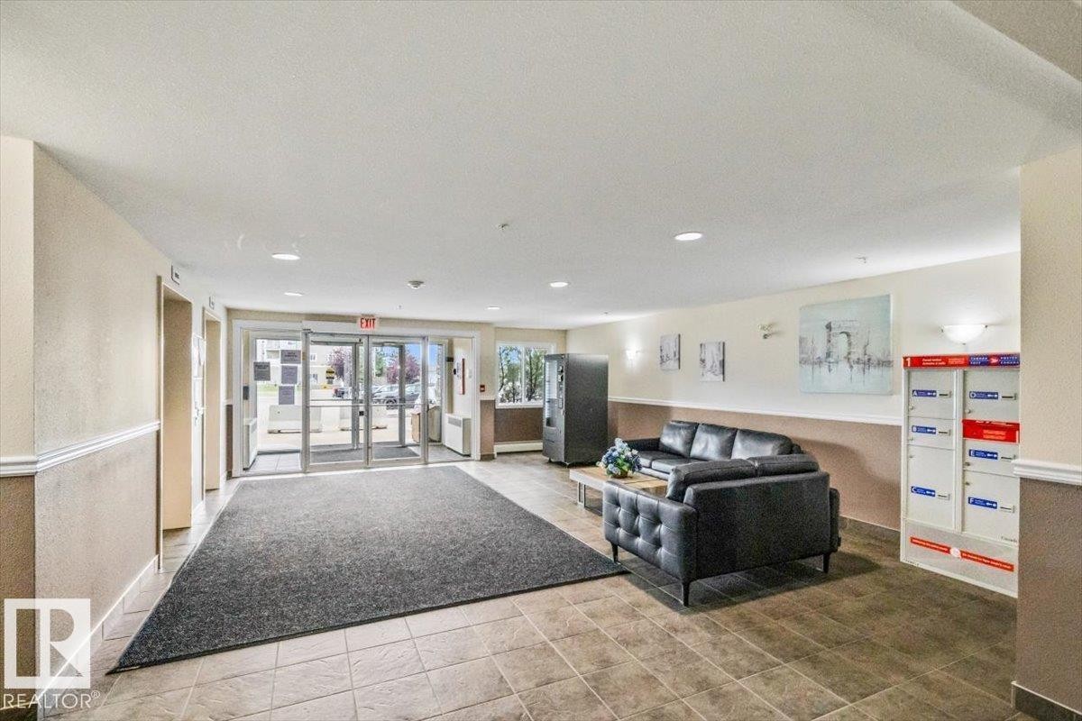Foyer featuring tiled flooring, recessed lighting, double-pane glass entry doors, and wall sconces - #110 4309 33 St, Stony Plain, AB