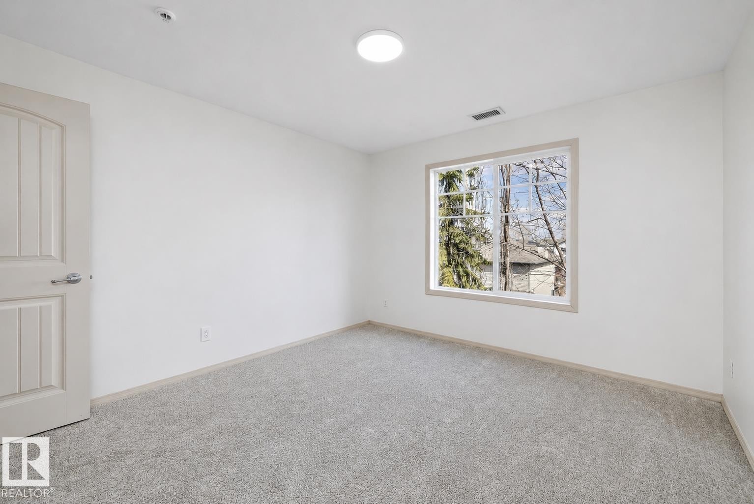 Bright room featuring neutral-toned carpet flooring and clean white walls - #353 2096 Blackmud Creek Dr Sw, Edmonton, AB - Indoor Photo Showing Other Room