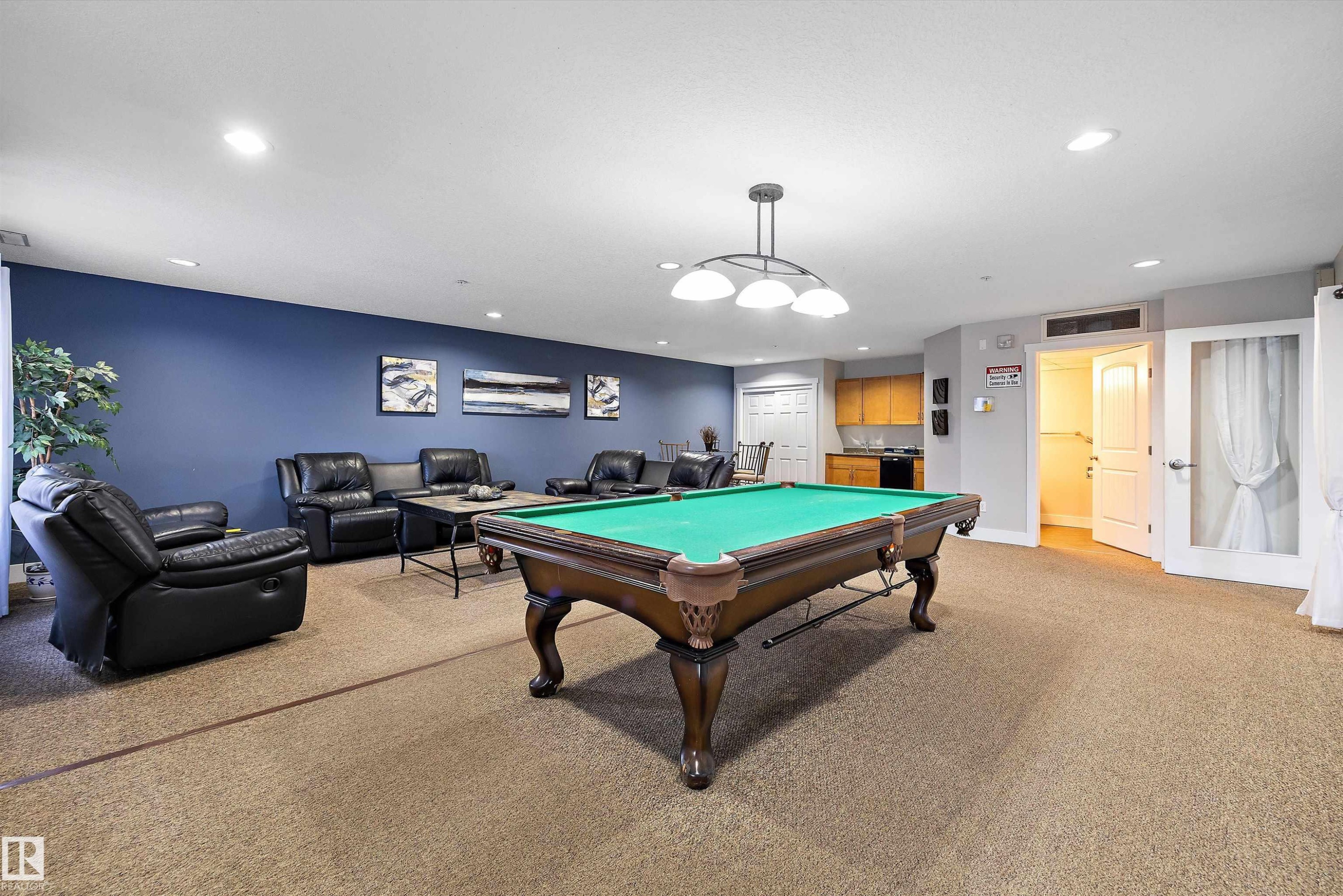 Spacious recreational room featuring a billiards table under a multi-bulb chandelier - #353 2096 Blackmud Creek Dr Sw, Edmonton, AB - Indoor Photo Showing Other Room