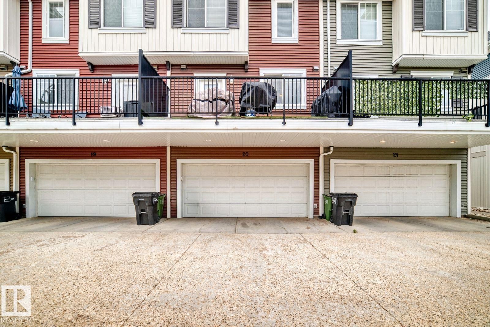 Attached garage with white panel door - #20 8315 180 Av Nw, Edmonton, AB