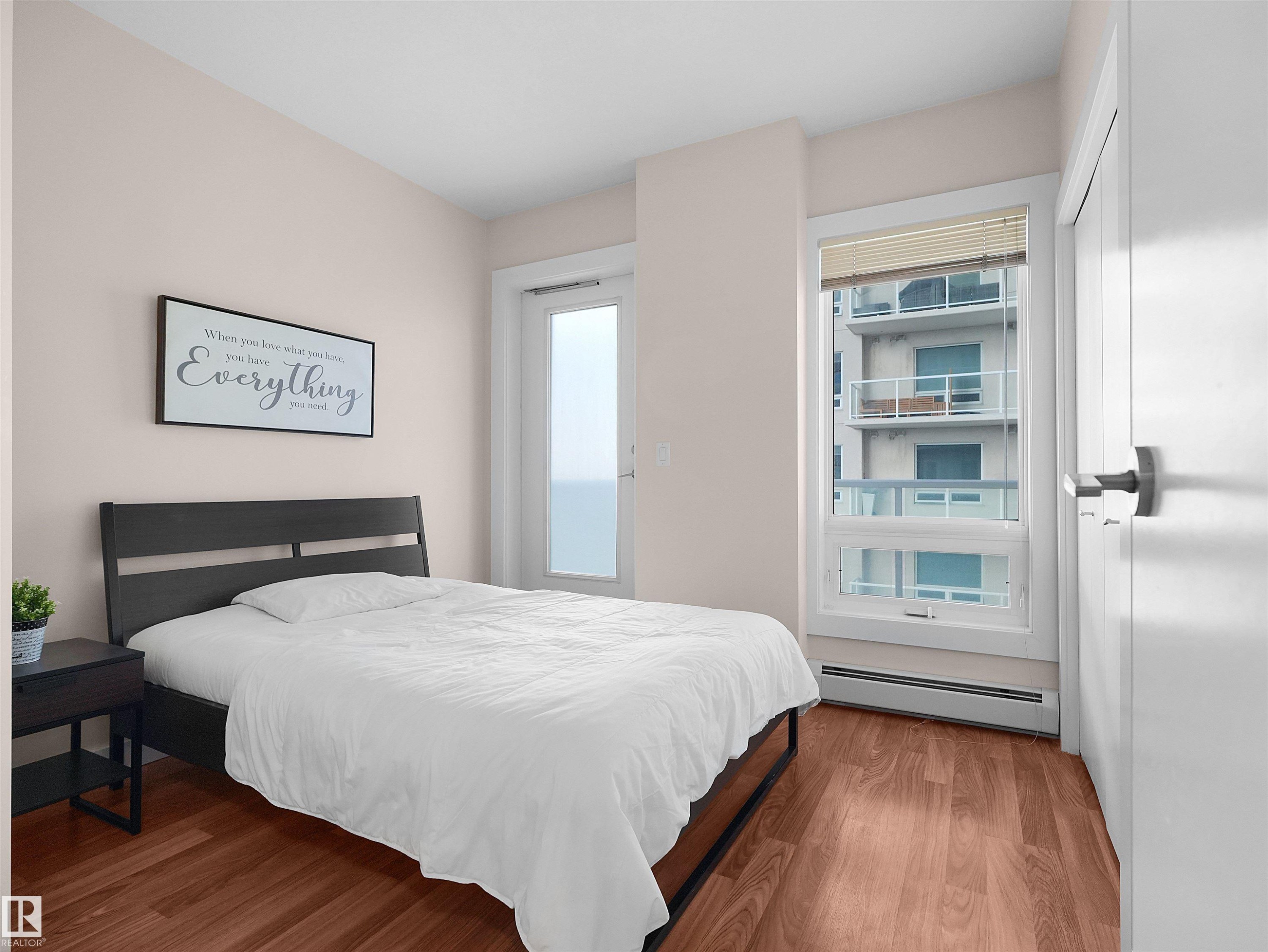 Wood-finish flooring, white walls, and a window with blinds - #1601 10136 104 St Nw, Edmonton, AB