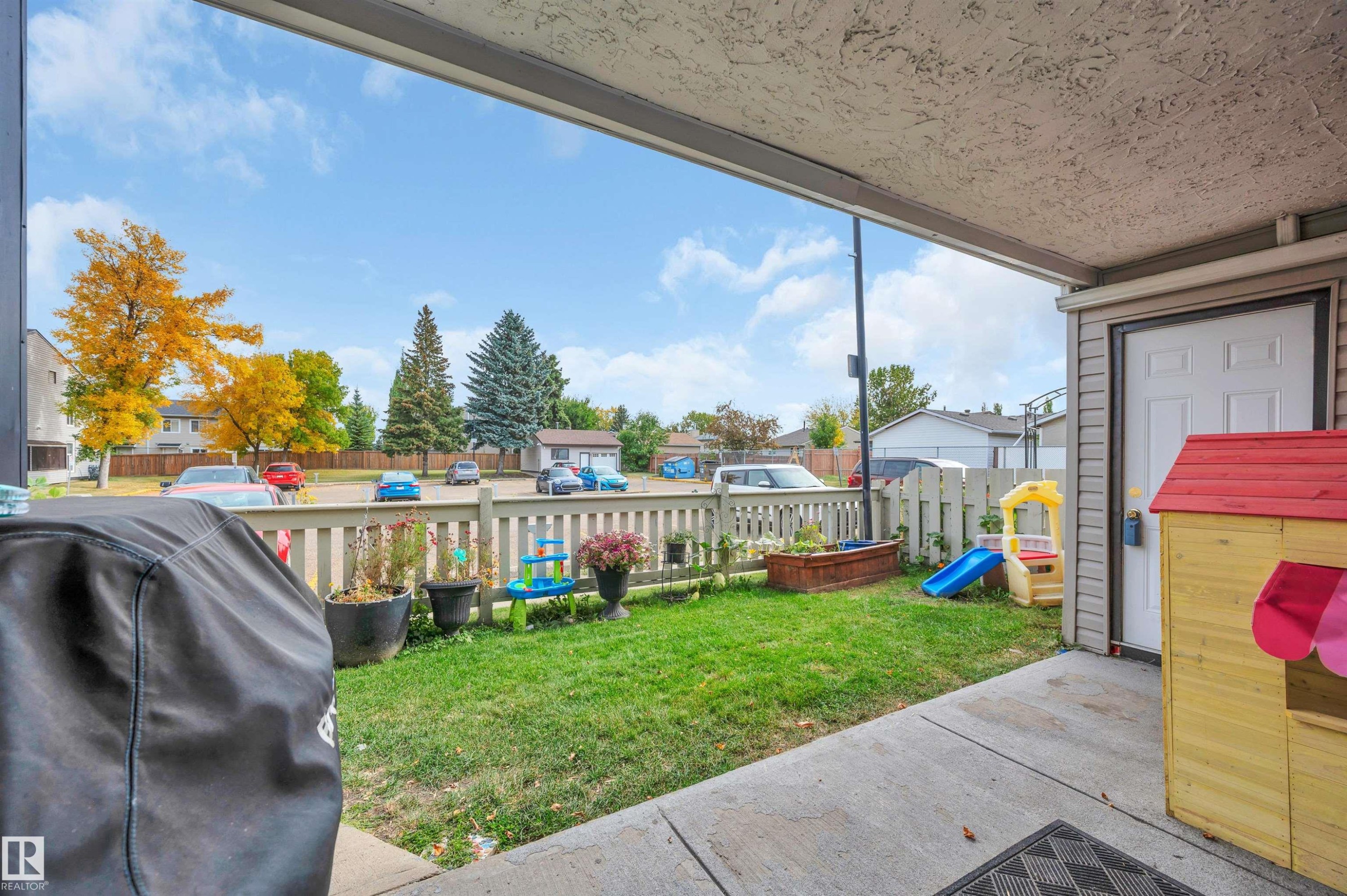 Covered patio area with concrete flooring - 15017 26 Street Nw, Edmonton, AB