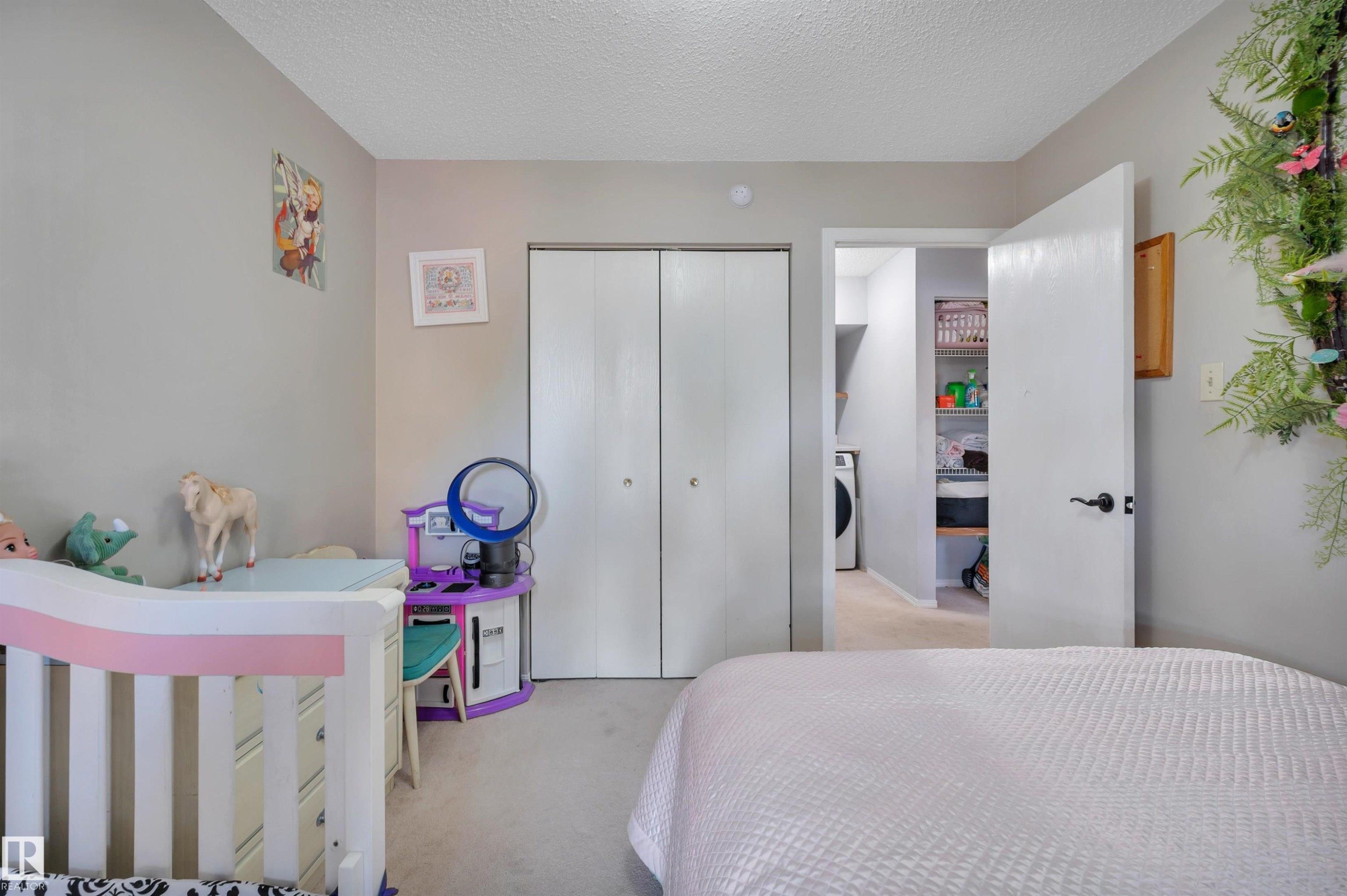 Neutral-toned walls complement the light-colored carpeting - 15017 26 Street Nw, Edmonton, AB