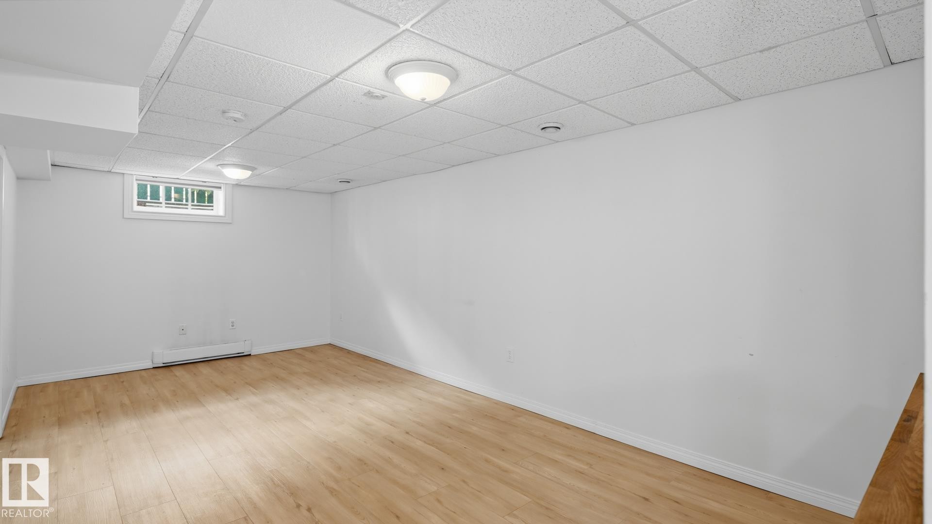 Wood-finish flooring, drop ceiling, recessed lighting, and wall-mounted baseboard heater - 11836 62 Street Nw, Edmonton, AB