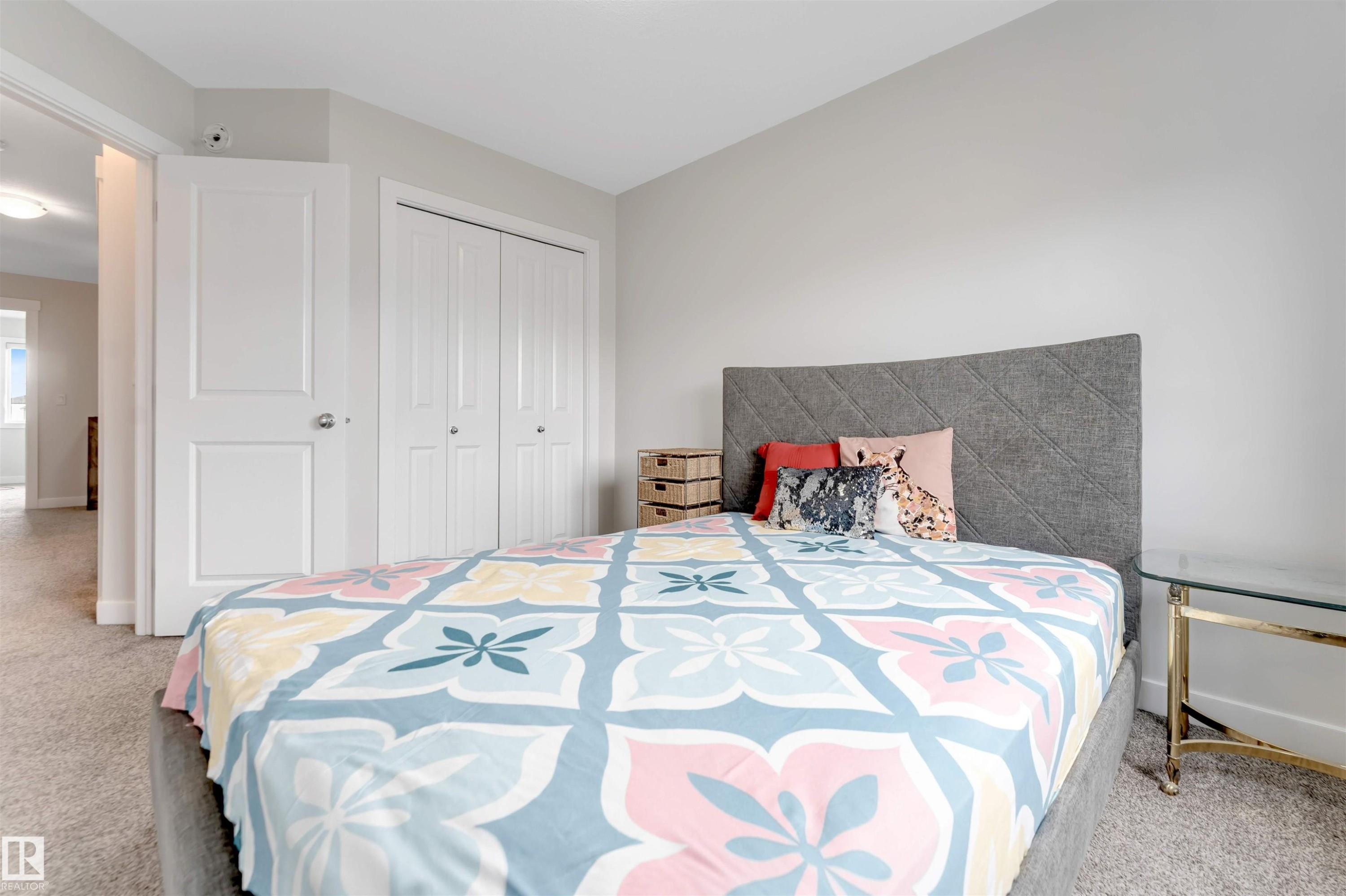 Plush carpeted flooring, neutral wall tones, and a built-in bi-fold door closet - 2004 15 Avenue Nw, Edmonton, AB