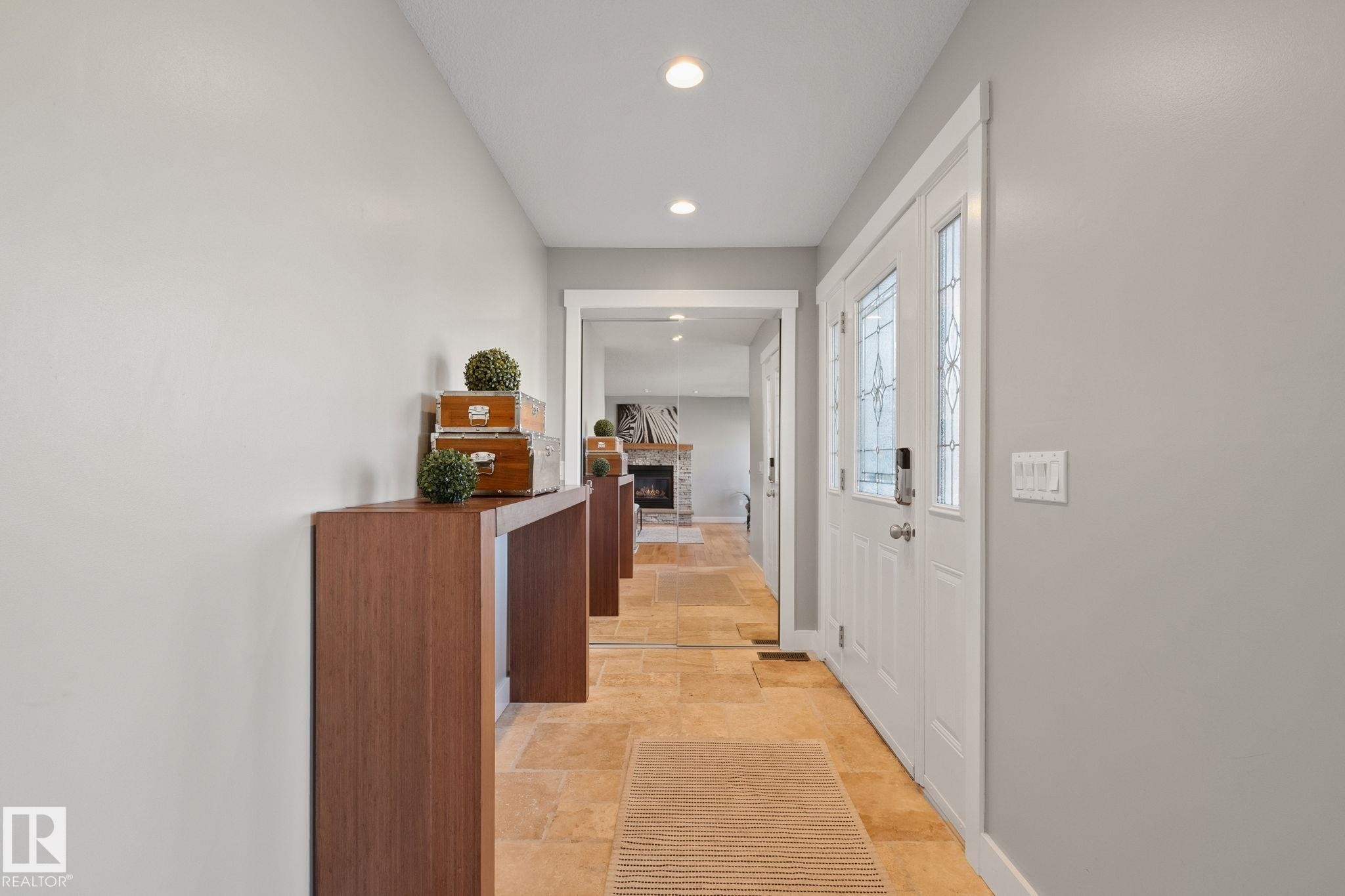 Recessed lighting, light-toned wall finishes, double entry doors with decorative glass inserts, and square tile flooring - 12403 29A Avenue Nw, Edmonton, AB