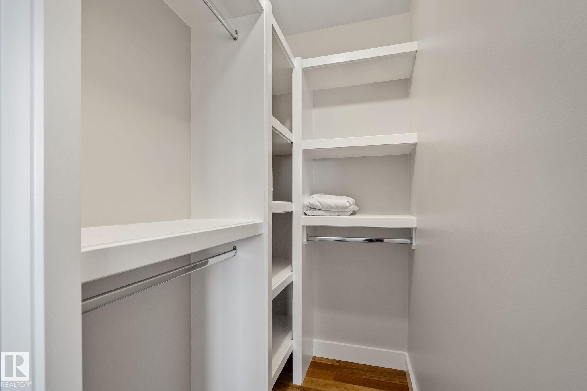 Built-in shelving, chrome hanging rods, and wood-finish flooring - 12403 29A Avenue Nw, Edmonton, AB