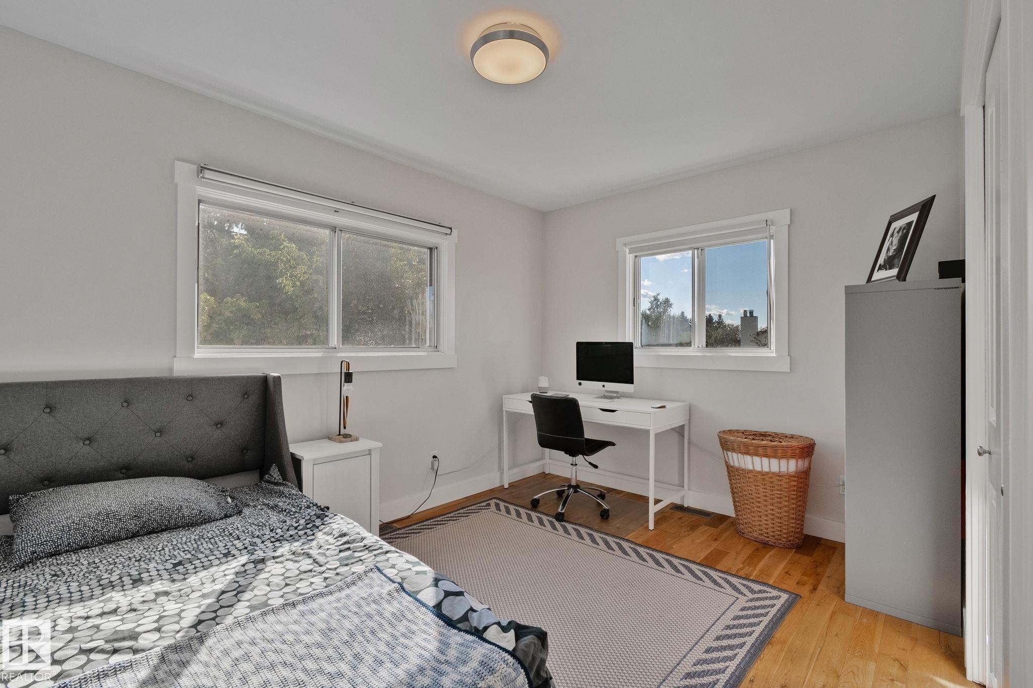 Hardwood flooring with a light finish, white walls, and a semi-flush mount ceiling light fixture - 12403 29A Avenue Nw, Edmonton, AB