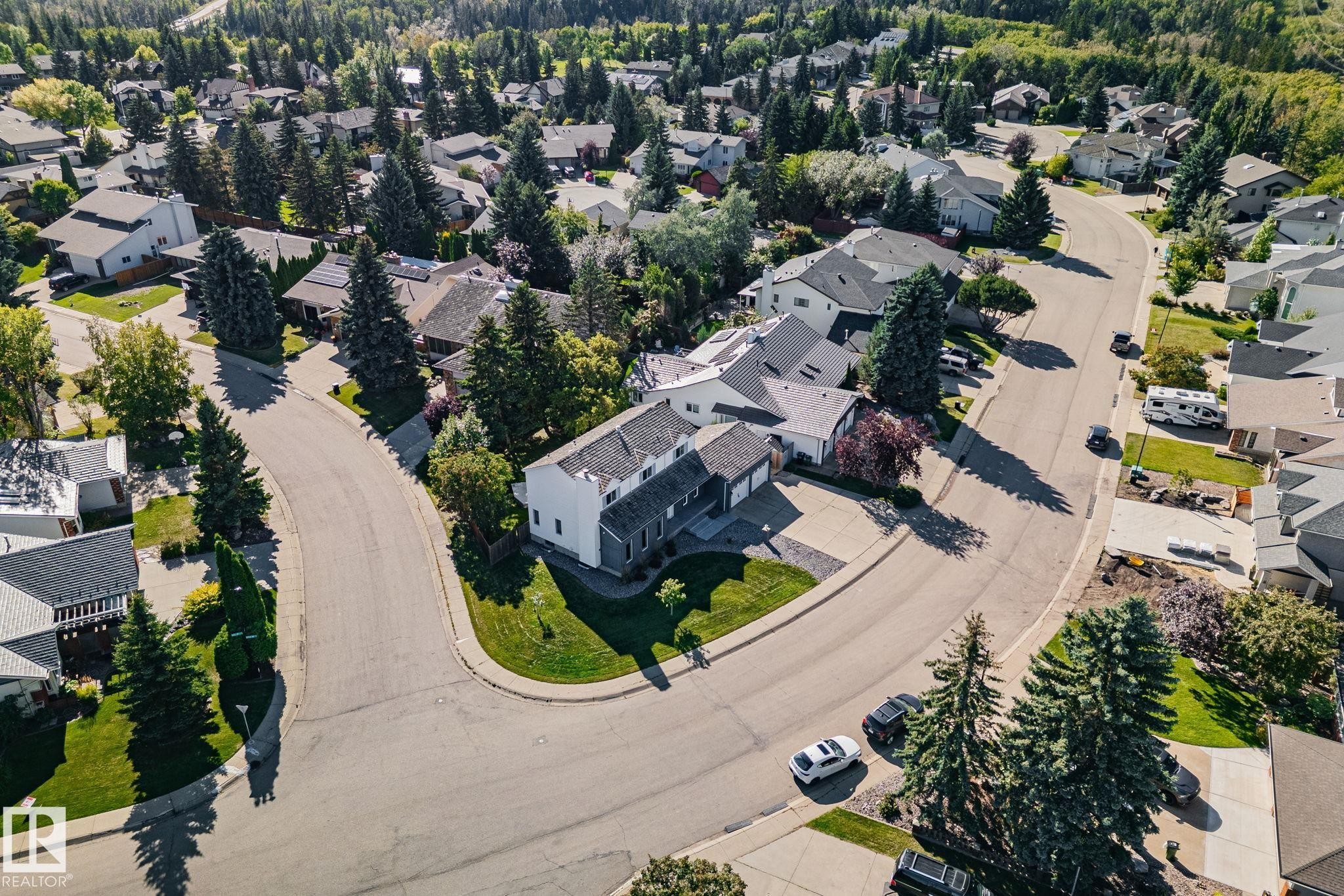 Curved street with surrounding residential properties, mature trees, and landscaping - 12403 29A Avenue Nw, Edmonton, AB