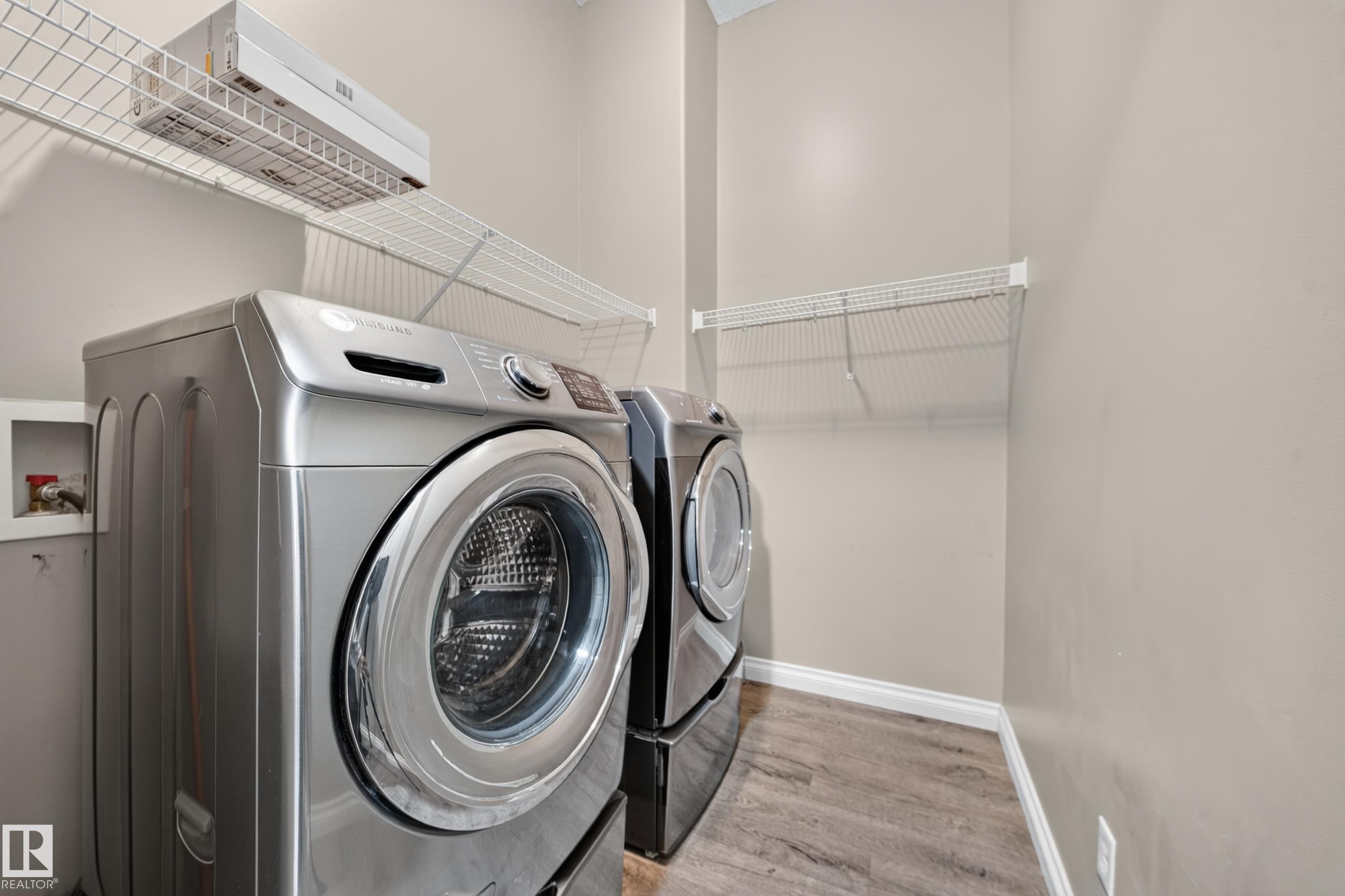 Laundry area with wire shelving and wood-finish flooring - 121 64 Street Sw, Edmonton, AB