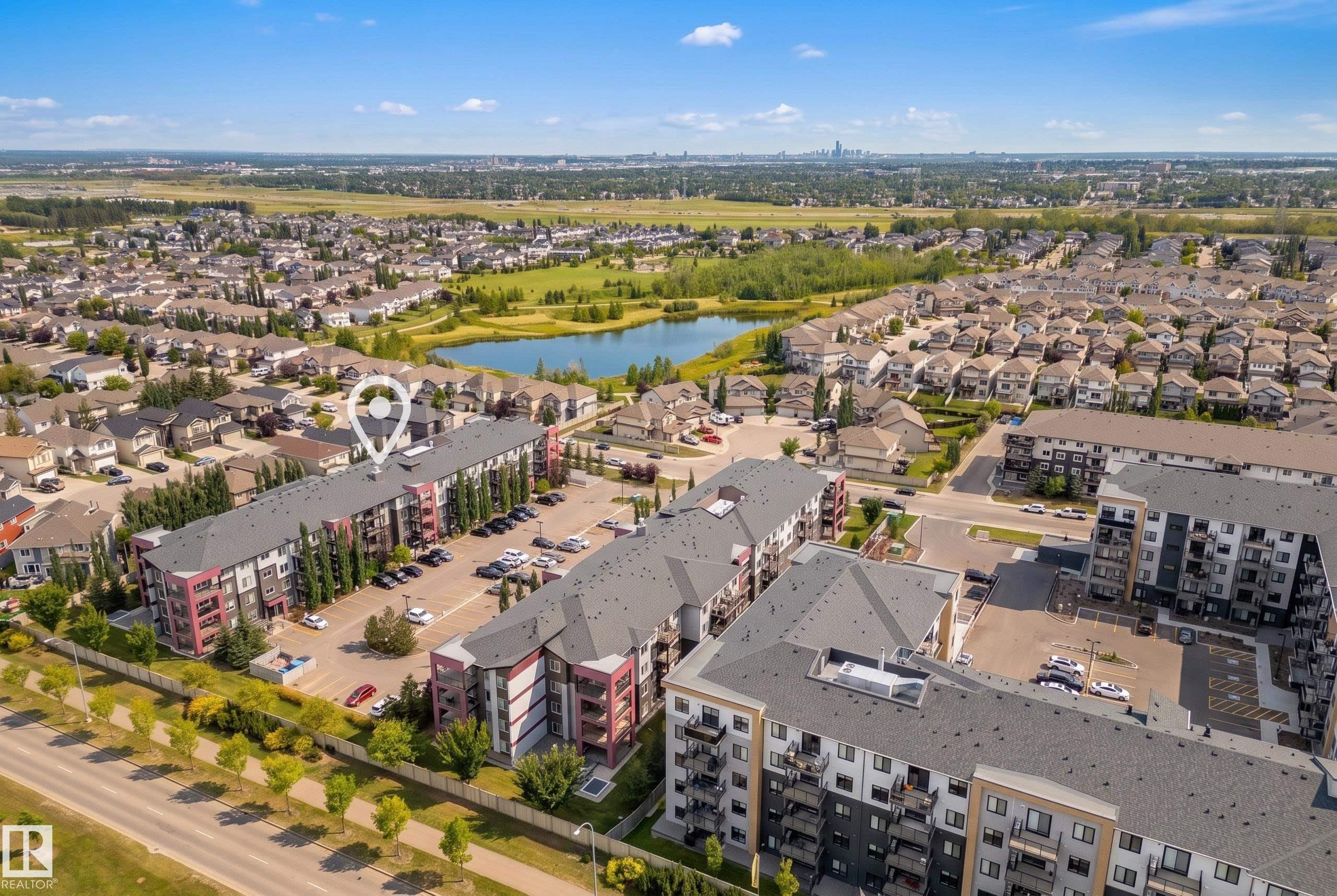 Multi-story residential buildings featuring balconies, surface parking, and landscaped grounds - #419 5515 7 Av Sw, Edmonton, AB