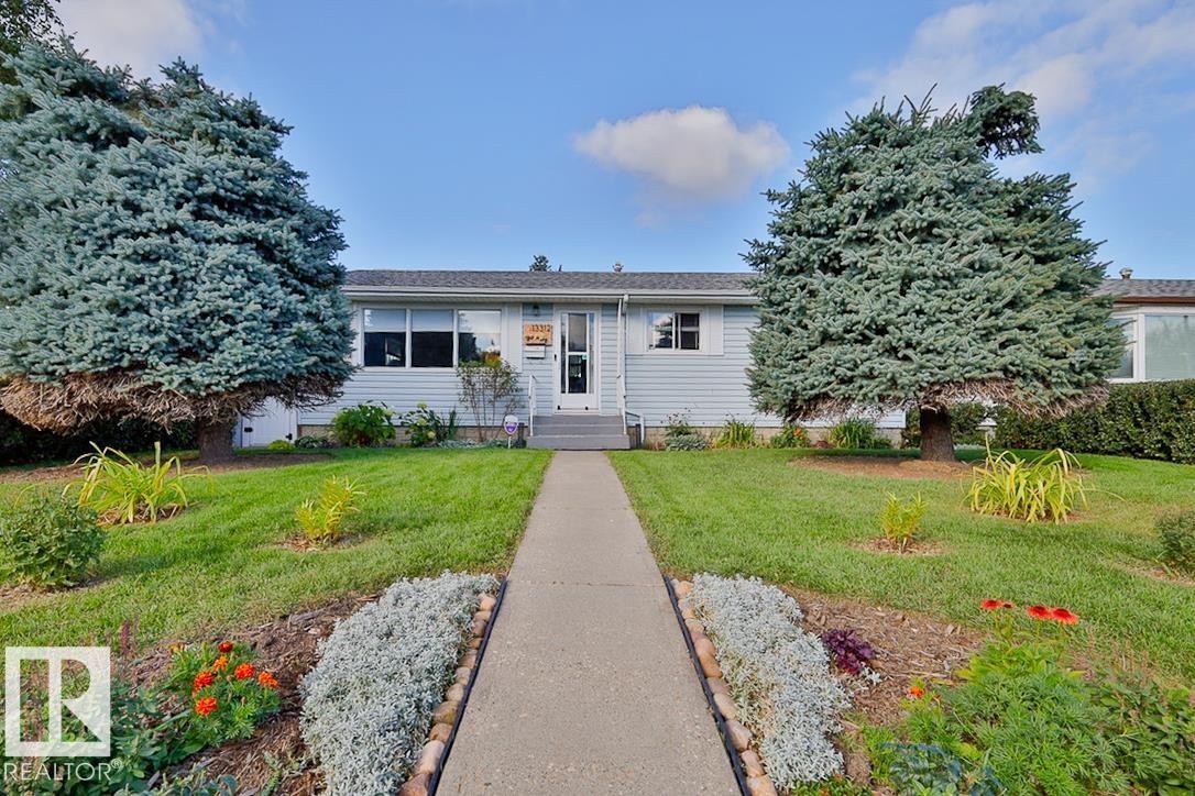 Single-story residence with light-colored siding, a front entry, and a paved walkway - 13312 123A Street Nw, Edmonton, AB