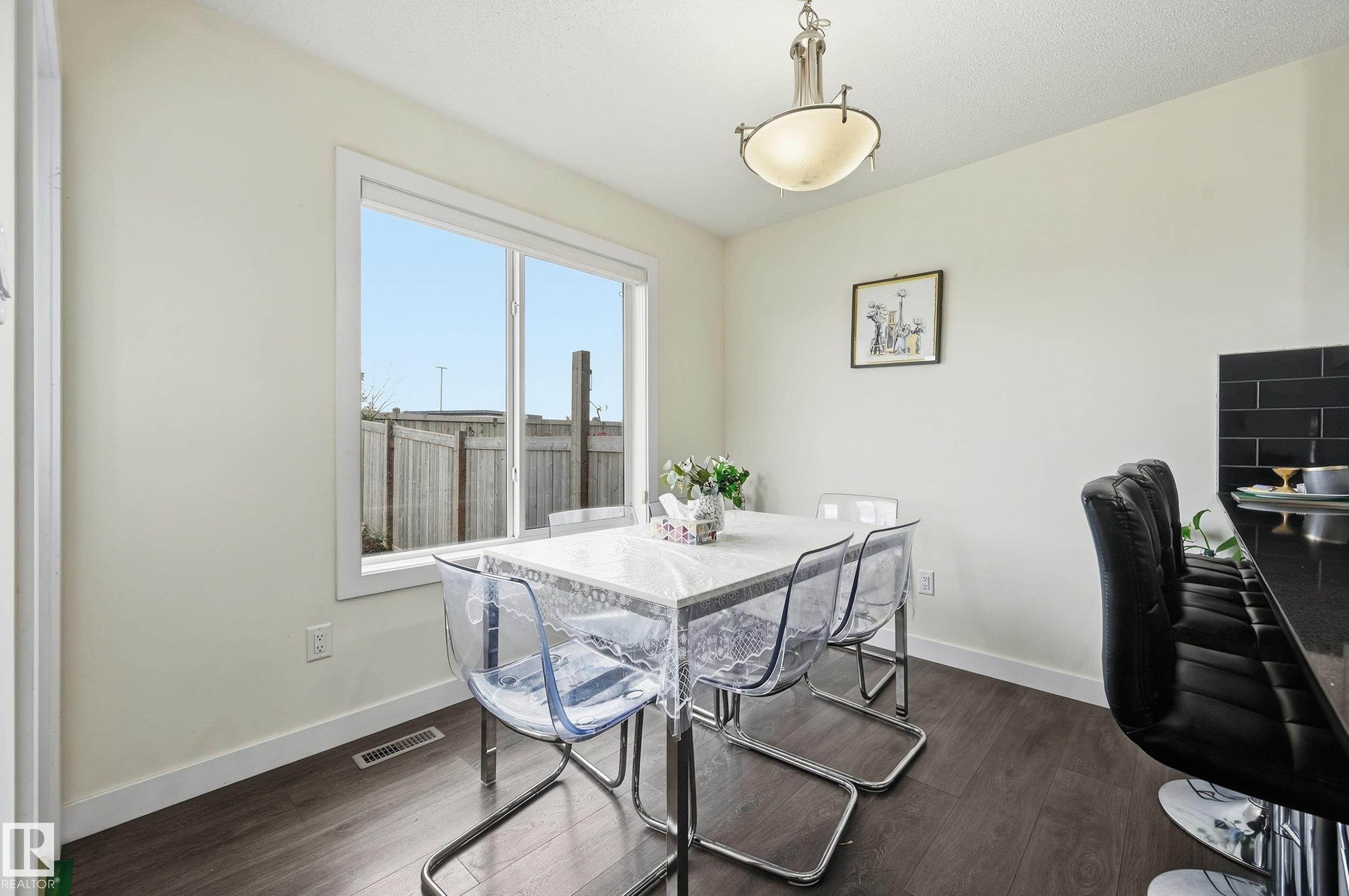 Recessed lighting, wood-finish flooring, white trim, and a window with a white frame - 941 Ebbers Crescent Nw, Edmonton, AB