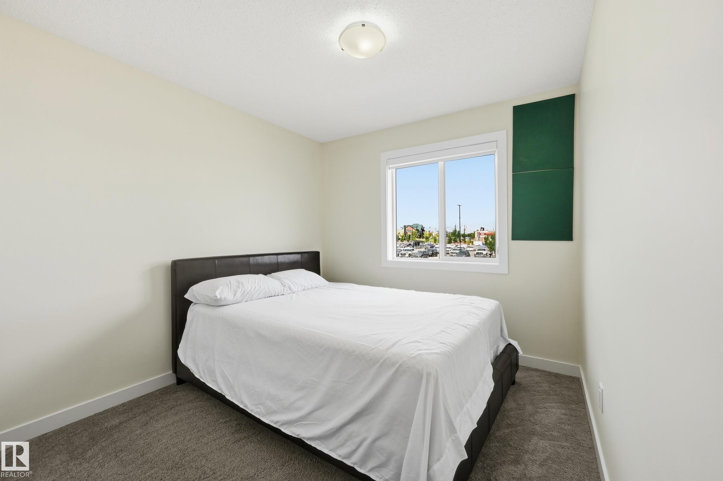 Carpeted room with a double-paned window, neutral wall paint, and a flush-mount ceiling light - 941 Ebbers Crescent Nw, Edmonton, AB
