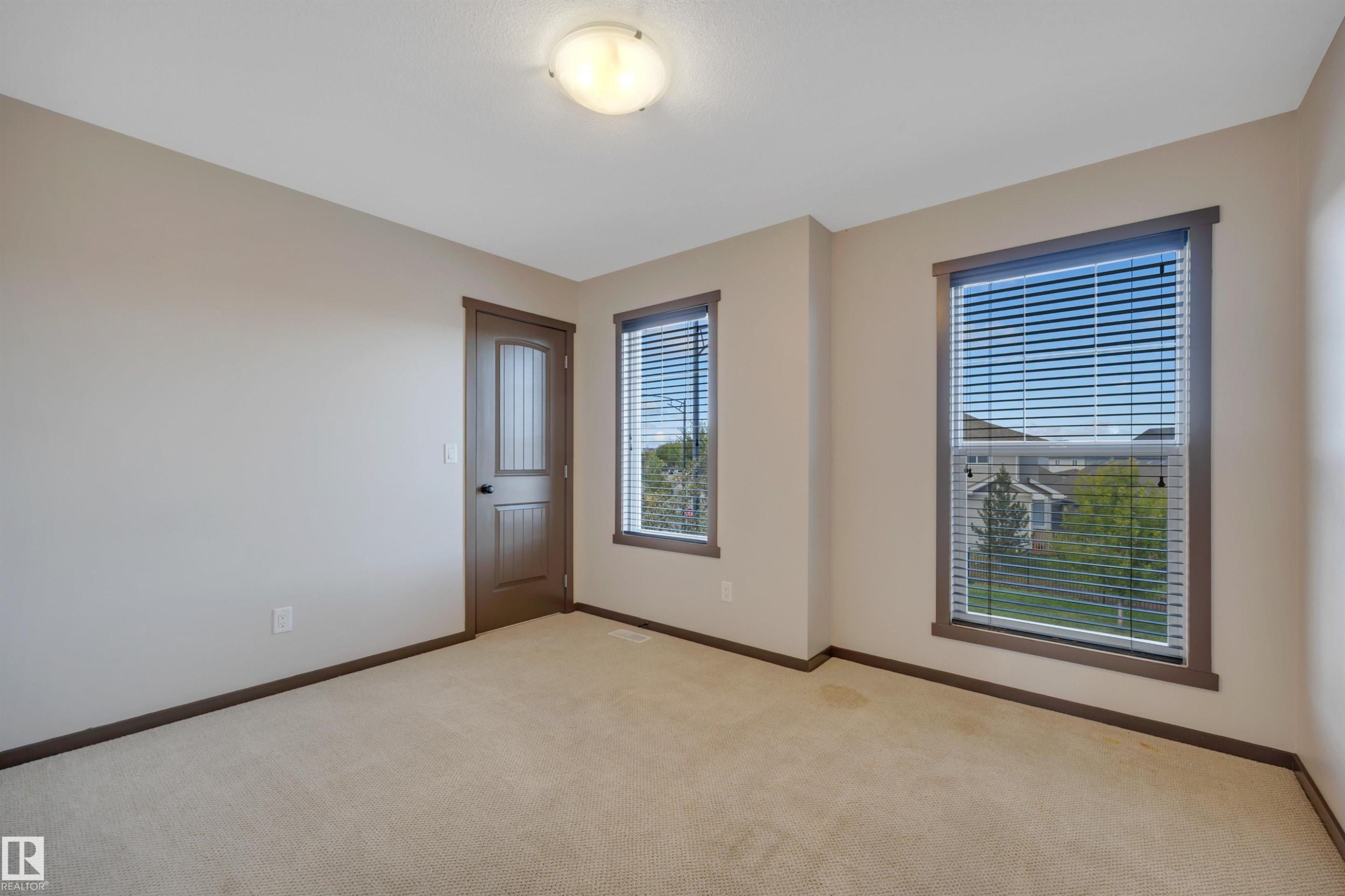 Neutral-toned walls complement the light-colored carpeting - 12903 205 Street Nw, Edmonton, AB