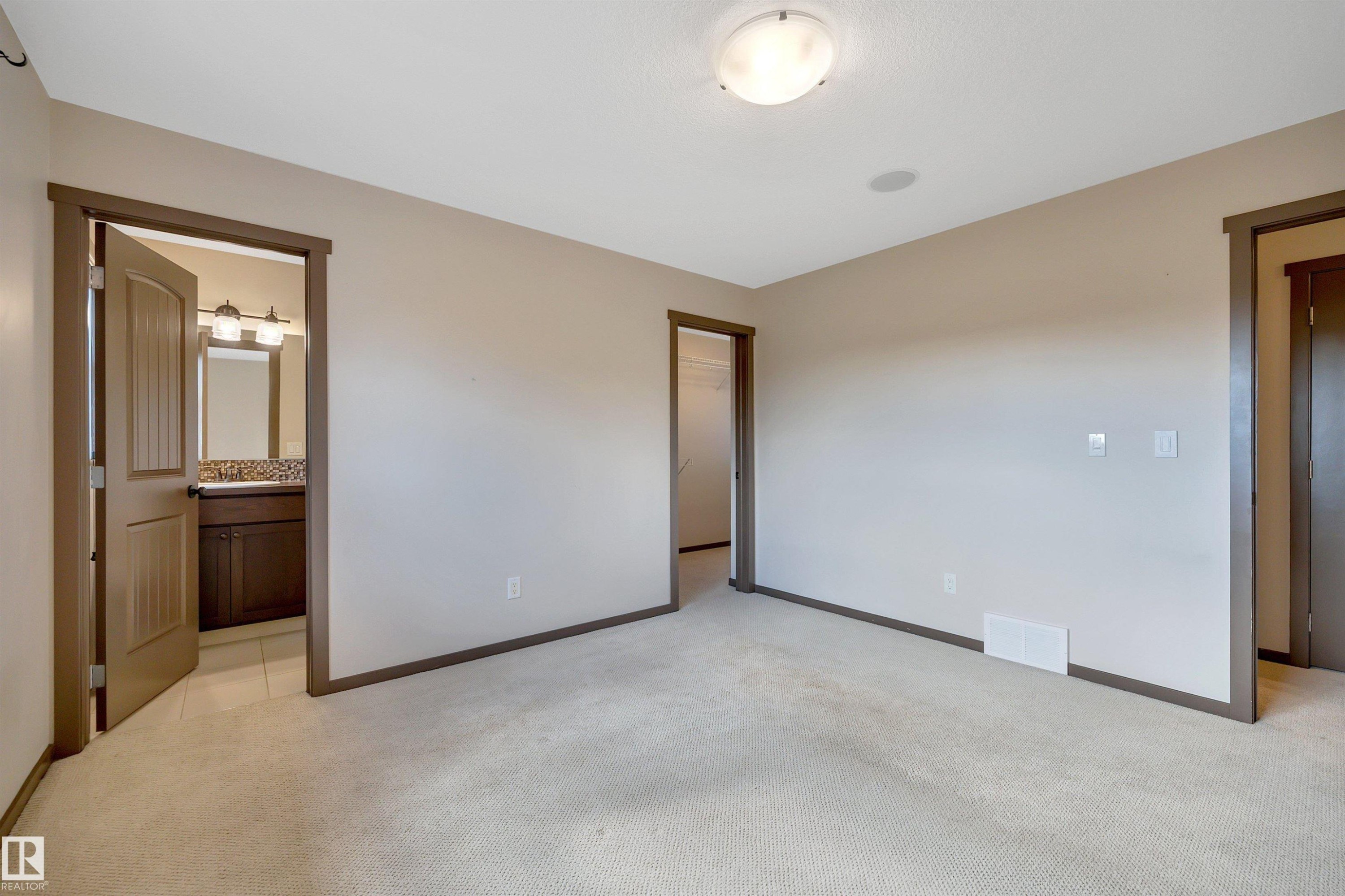 Neutral-toned carpeting, recessed ceiling speaker, and flush-mount ceiling light fixture - 12903 205 Street Nw, Edmonton, AB