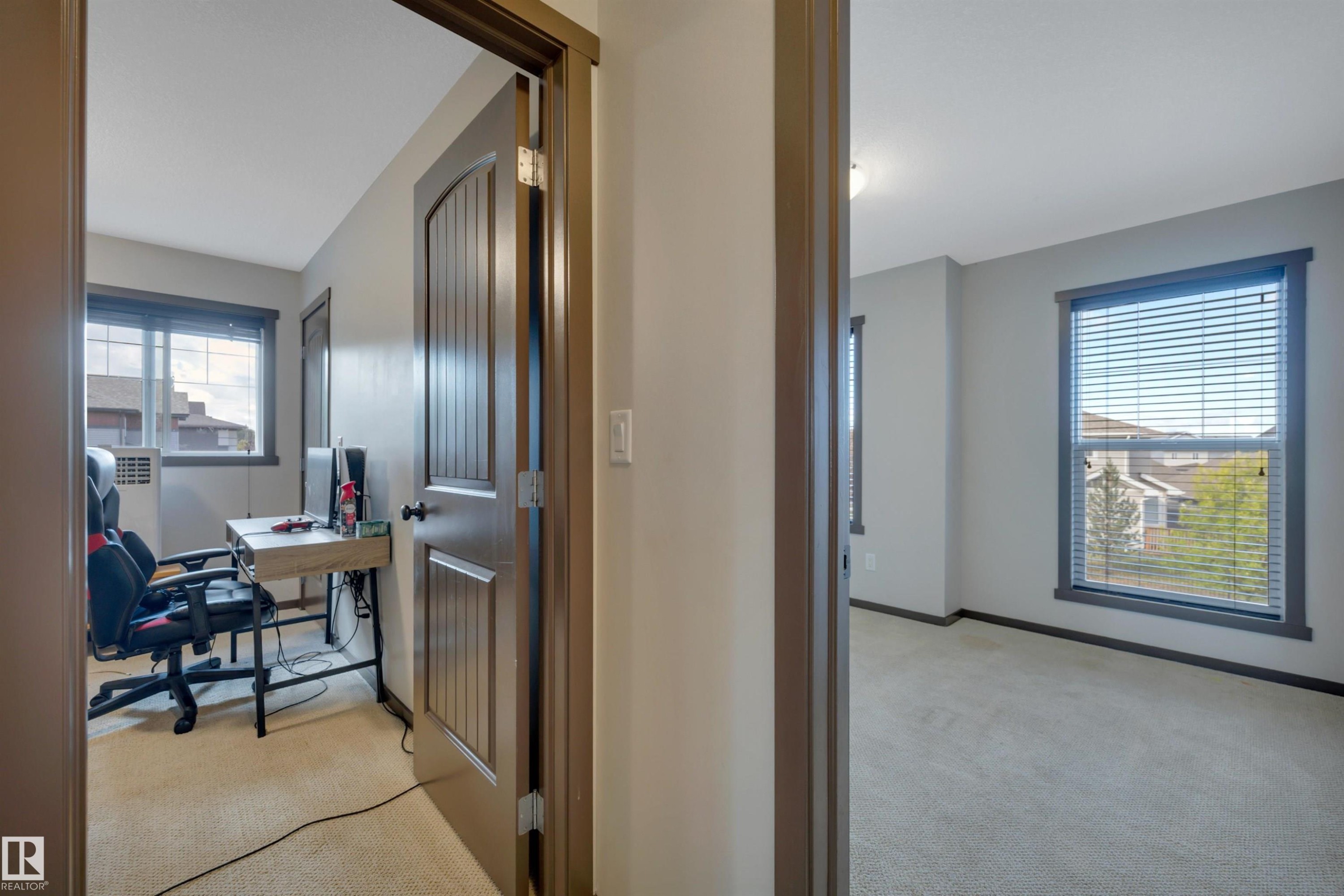Neutral wall paint, carpeted flooring, and dark trim details - 12903 205 Street Nw, Edmonton, AB