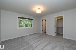 Neutral paint palette, recessed lighting fixture, large window, soft carpeting, and an integrated closet system - 