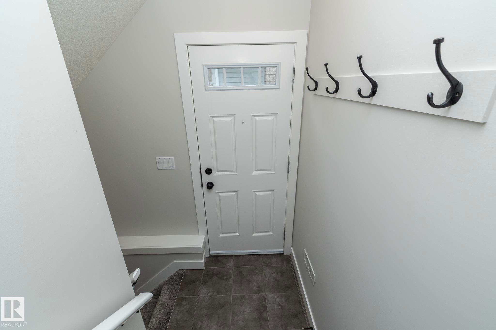 White paneled door with transom window - 53/55 Michigan Street, Devon, AB