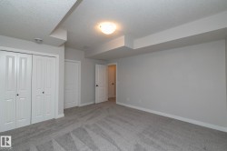 Gray carpeting, light gray wall paint, white trim, white doors, and a ceiling-mounted light fixture - 