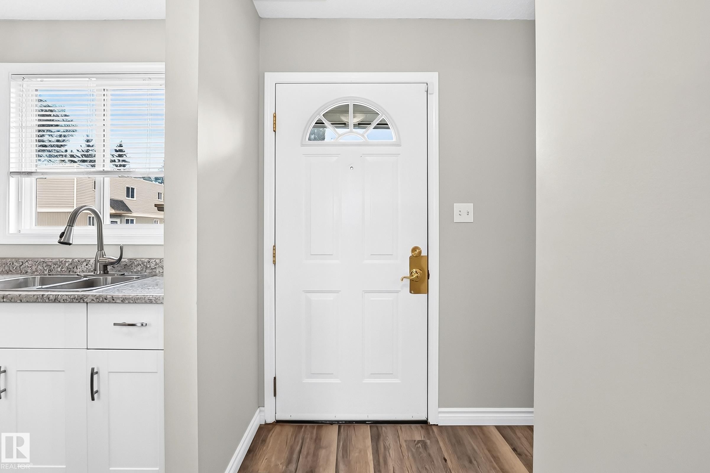 Entry door with arched window detail and brass hardware - 18146 81 Avenue Nw, Edmonton, AB