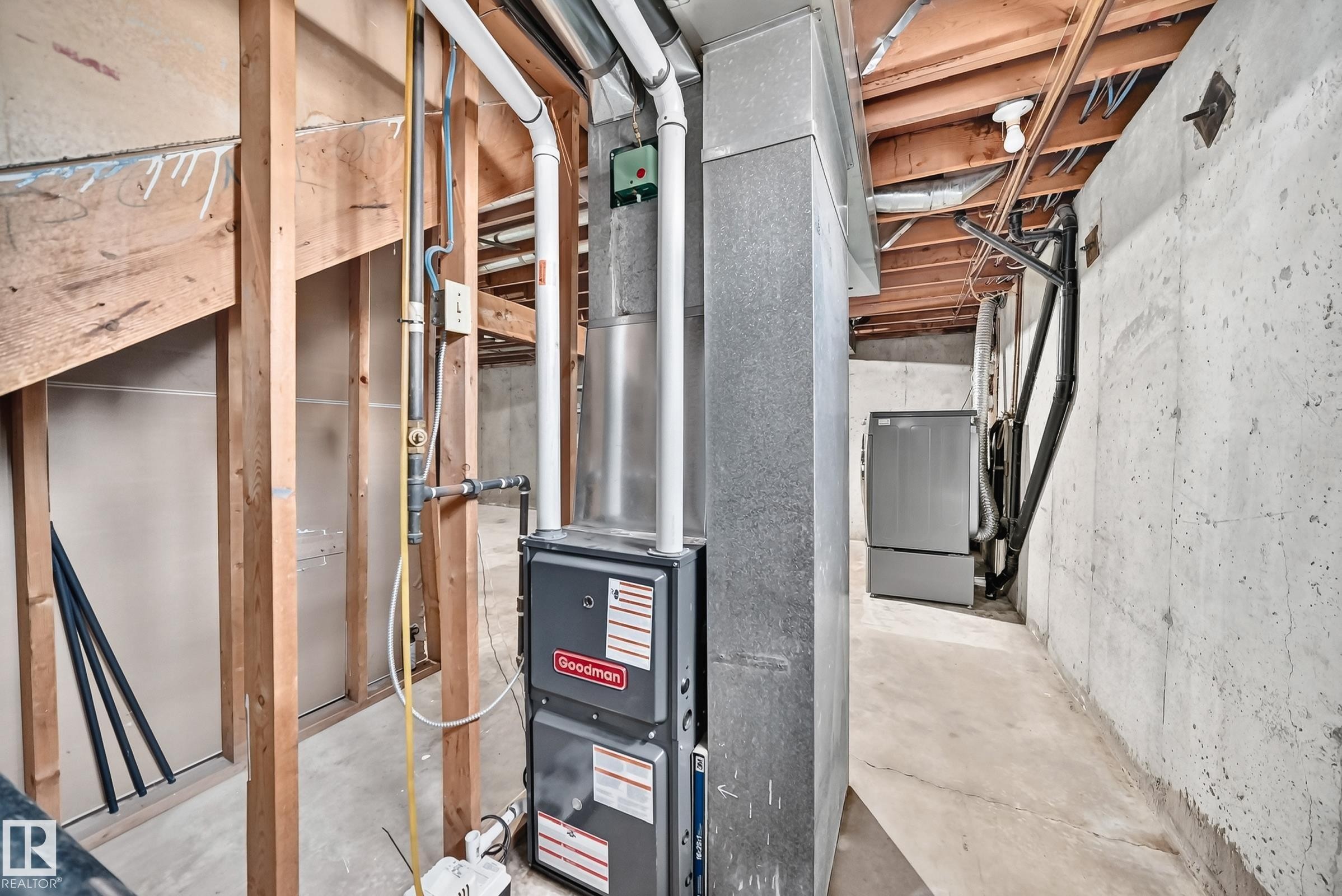 Unfinished basement area with exposed wood framing, concrete flooring, and exposed ceiling joists - 18146 81 Avenue Nw, Edmonton, AB