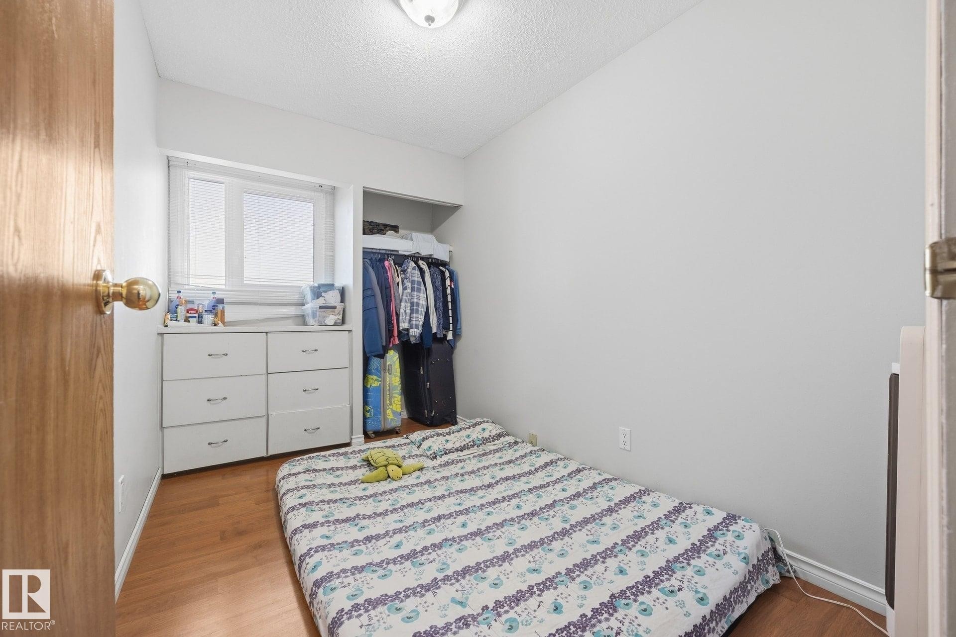 Wood-finish flooring, built-in window and storage unit, and open closet space - #2 14120 80 St Nw, Edmonton, AB
