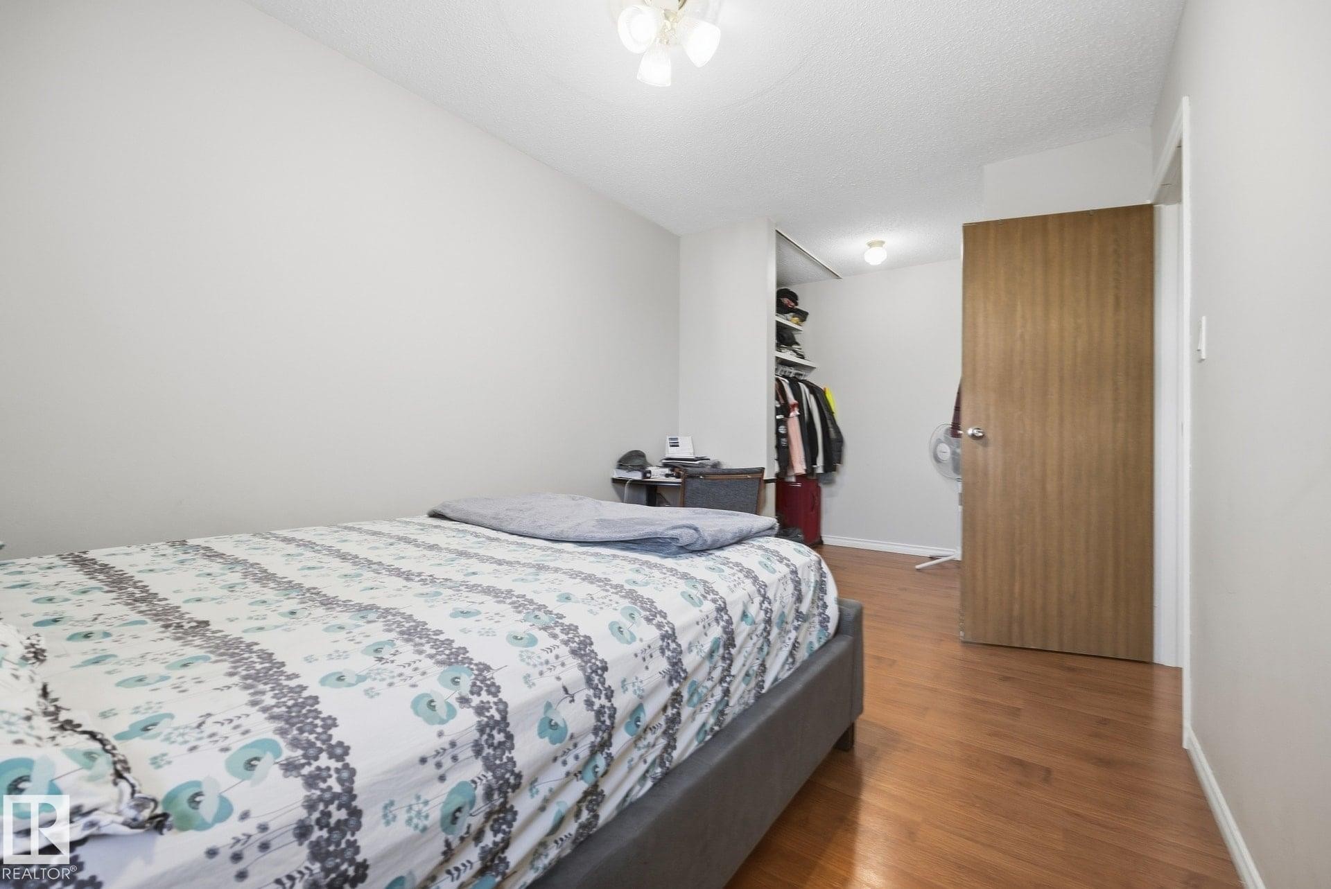 Wood-finish flooring, recessed lighting, and a built-in closet with shelving - #2 14120 80 St Nw, Edmonton, AB