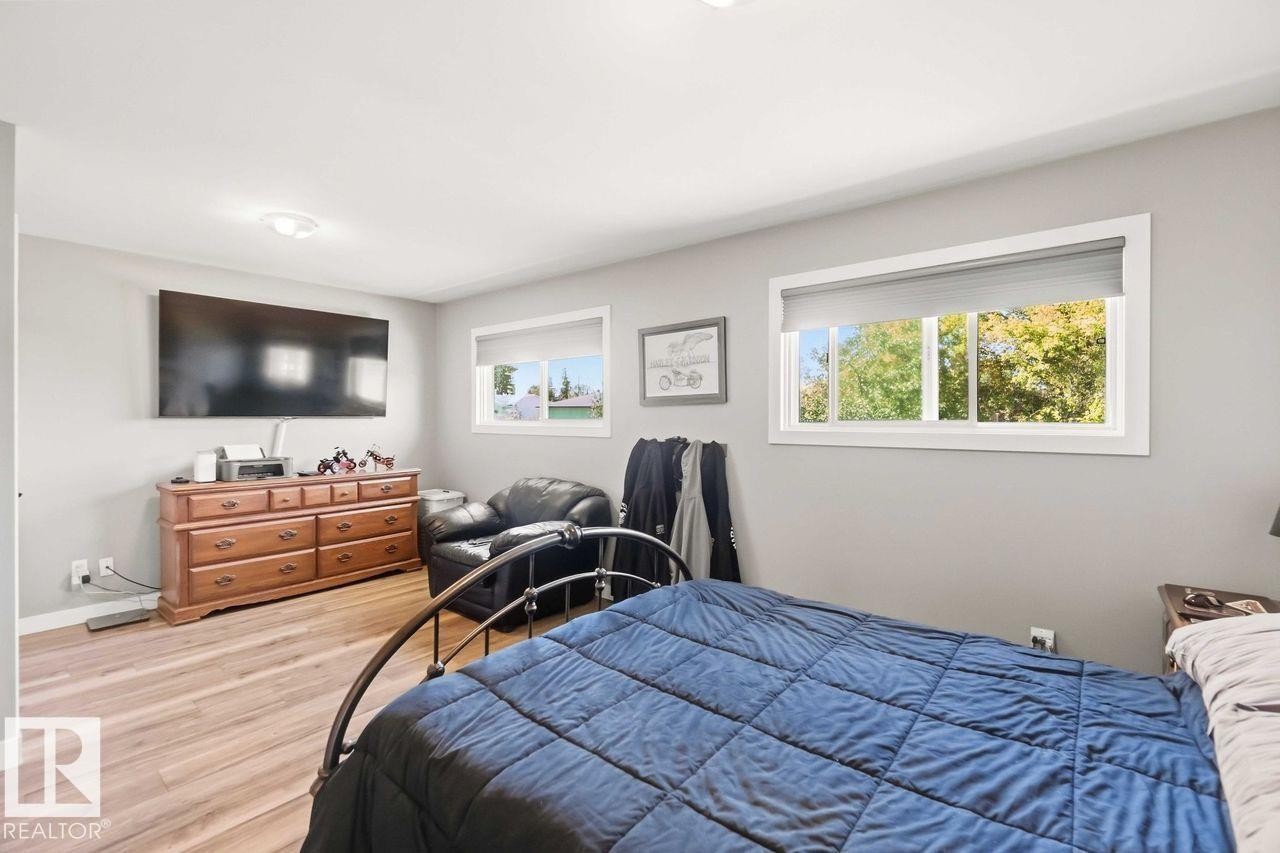 Wood-finish flooring with a neutral wall color, recessed lighting, and multiple windows - 13427 83 Street Nw, Edmonton, AB