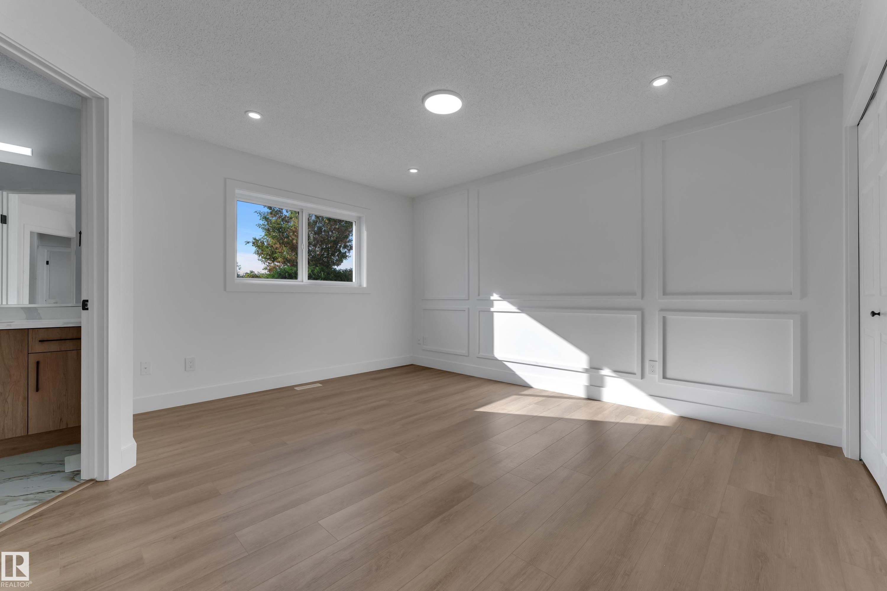 Wood-finish flooring, recessed lighting, and a window with exterior views - 3320 43 Street Nw, Edmonton, AB