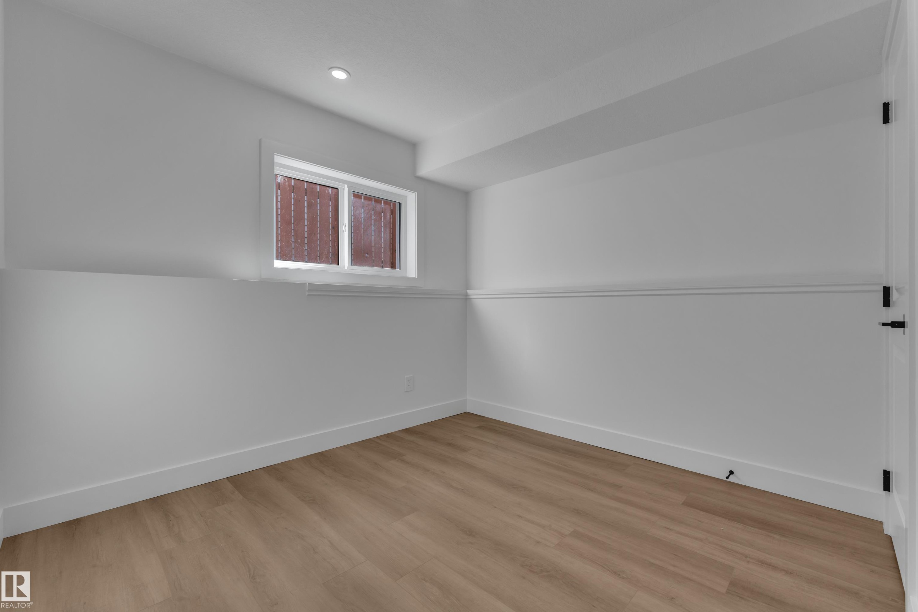 Recessed ceiling lighting, wood-finish flooring, crisp white walls, white trim, and a window for natural illumination - 3320 43 Street Nw, Edmonton, AB