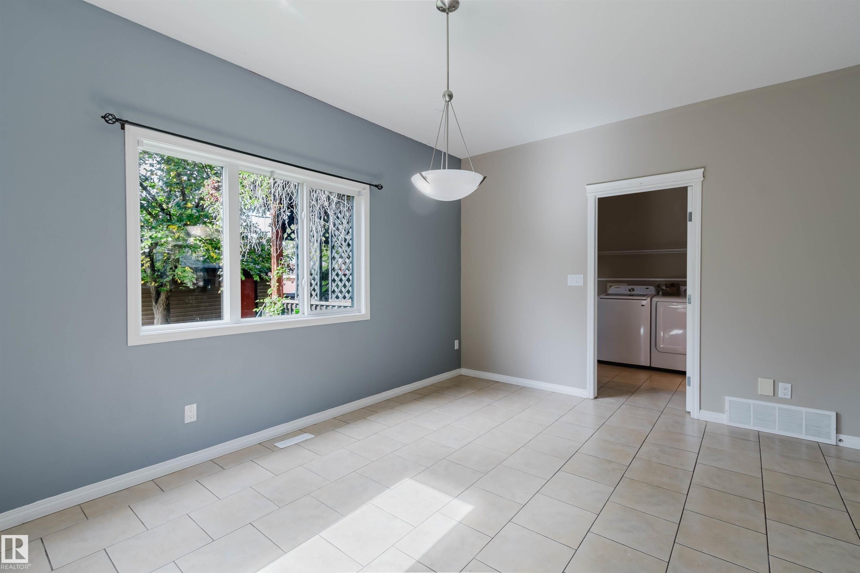 Recessed ceiling light, built-in shelving, tile flooring, window with white frame, and white trim - 11608 96 Street Nw, Edmonton, AB