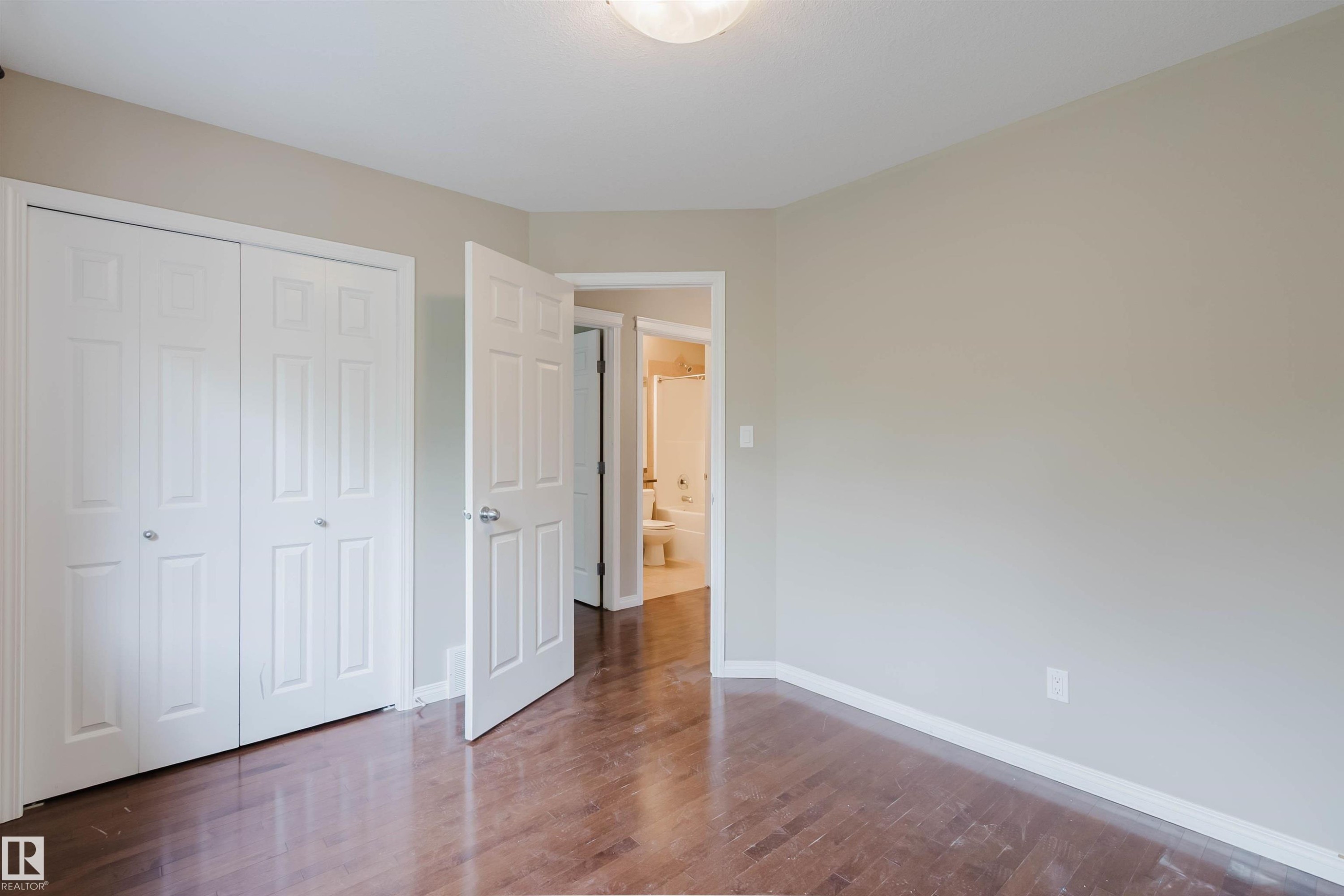 Wood-finish flooring with a neutral wall palette and white trim - 11608 96 Street Nw, Edmonton, AB