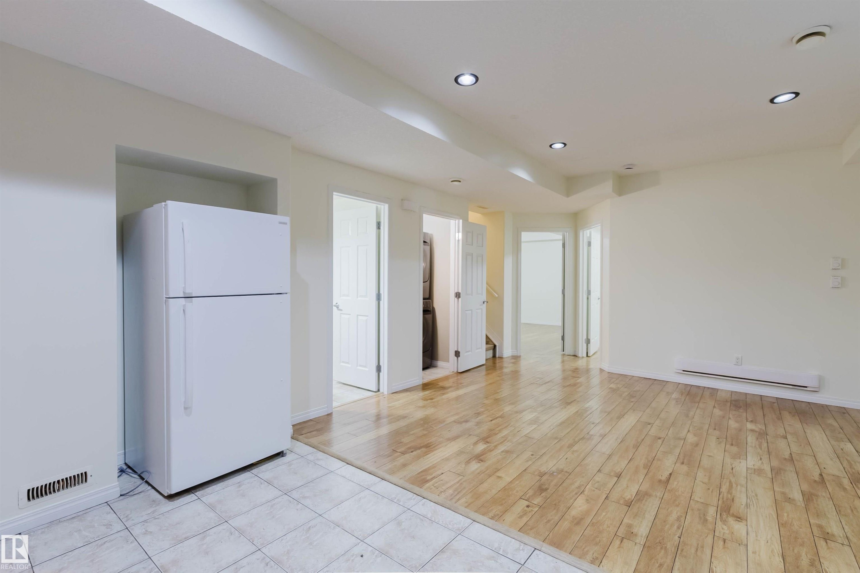 Recessed lighting, wood-finish flooring, white tile flooring, built-in refrigerator, and multiple interior doorways - 11608 96 Street Nw, Edmonton, AB