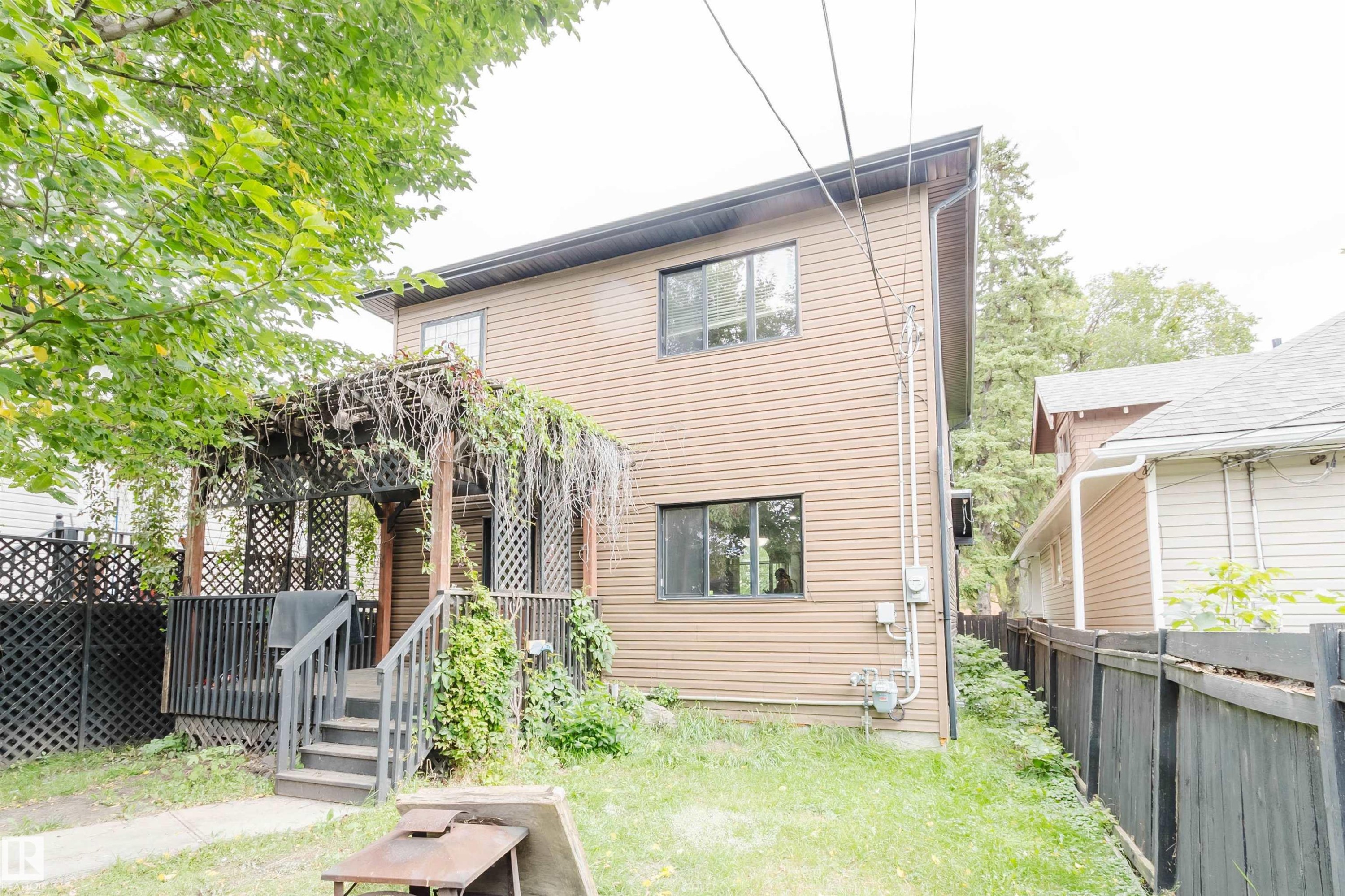 Two-story property with brown horizontal siding - 11608 96 Street Nw, Edmonton, AB
