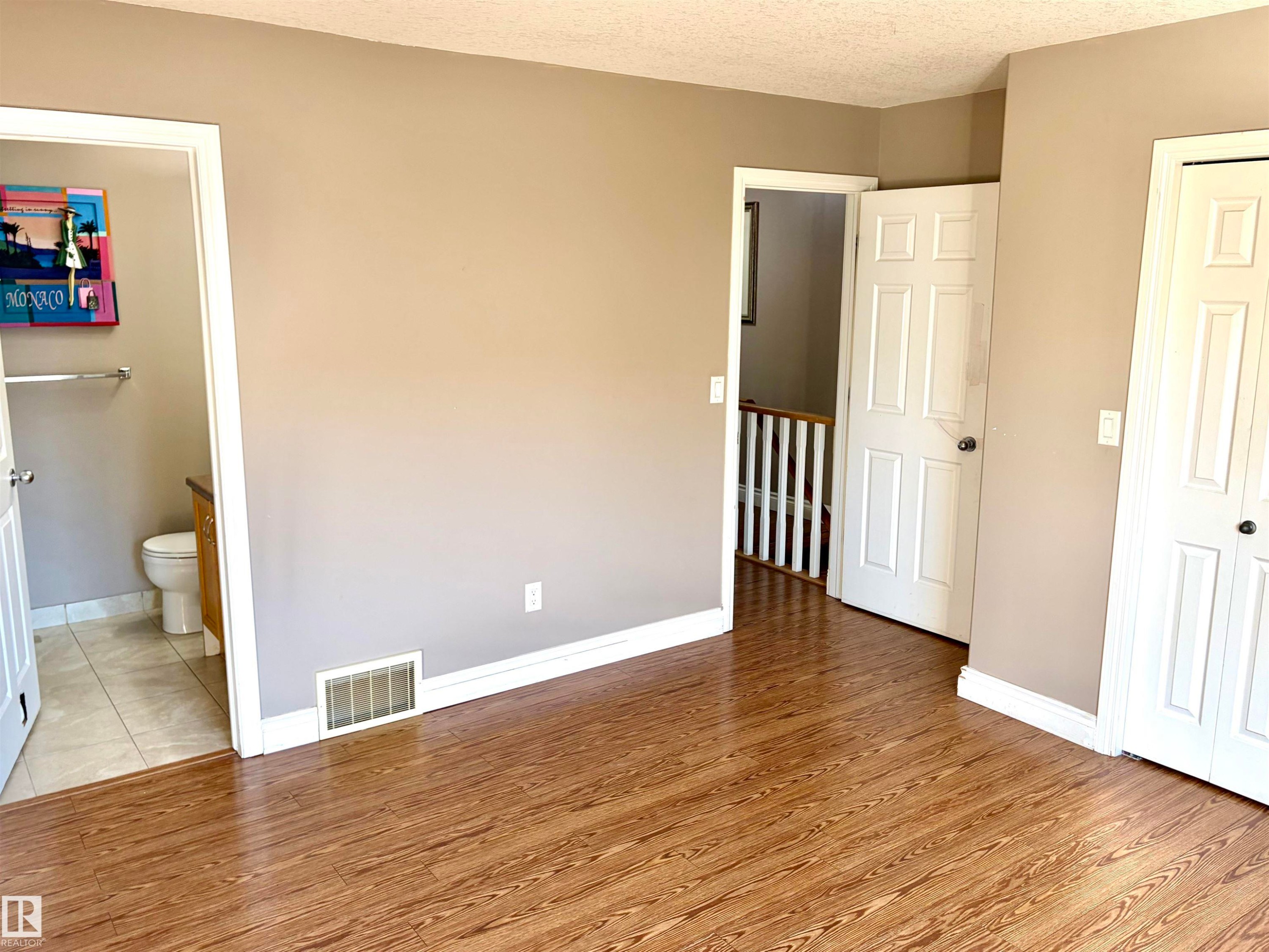 Wood-finish flooring throughout, with a neutral wall palette - #17 16317 64 St Nw, Edmonton, AB