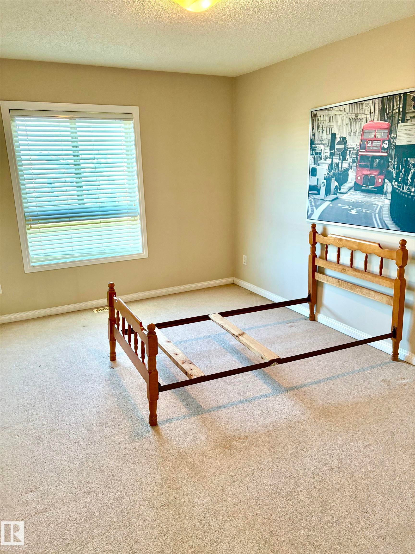 Window with horizontal blinds, neutral wall paint, and ceiling-mounted light fixture - #17 16317 64 St Nw, Edmonton, AB