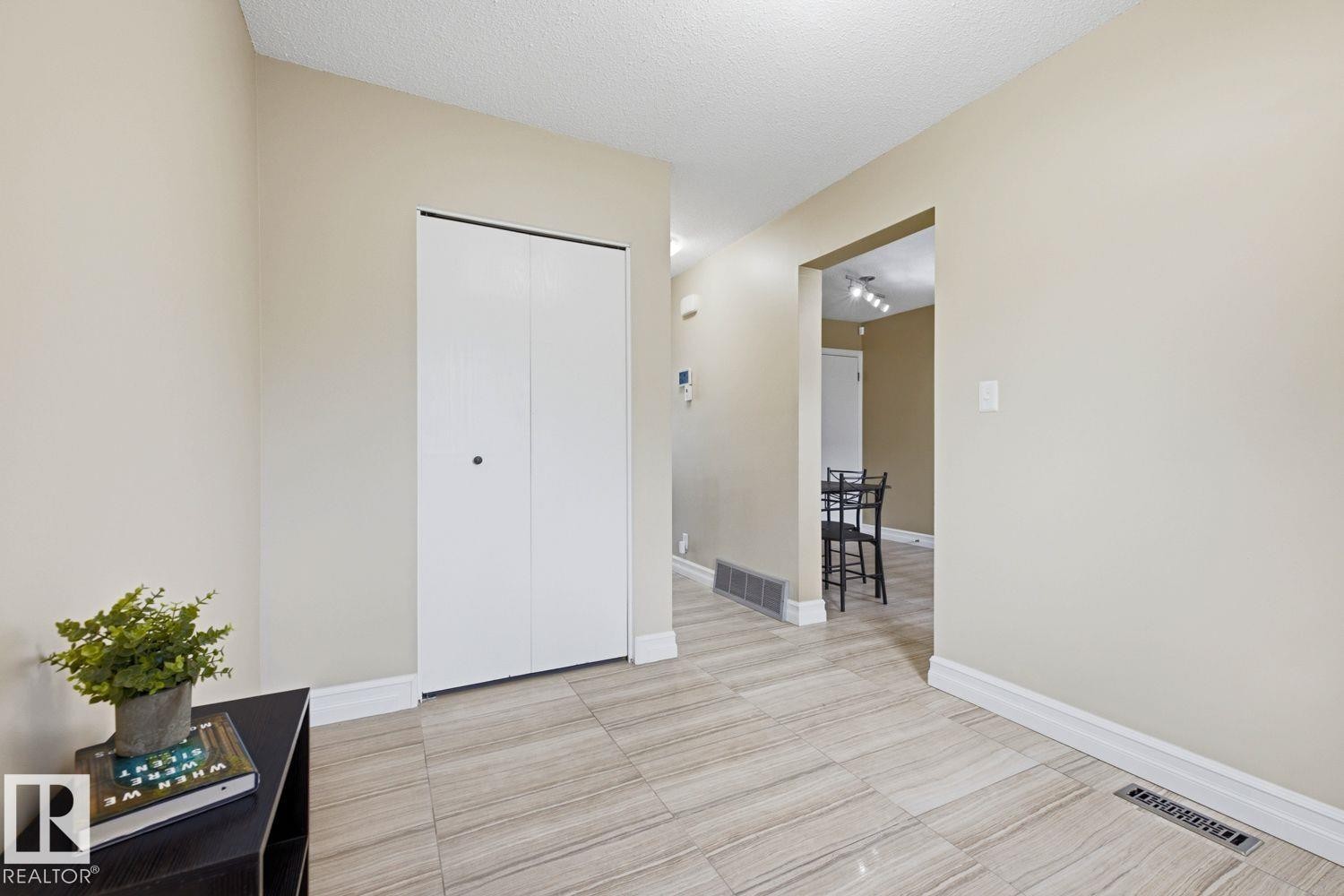 Light-toned walls complement the striped tile flooring - 11317 22 Avenue Nw, Edmonton, AB